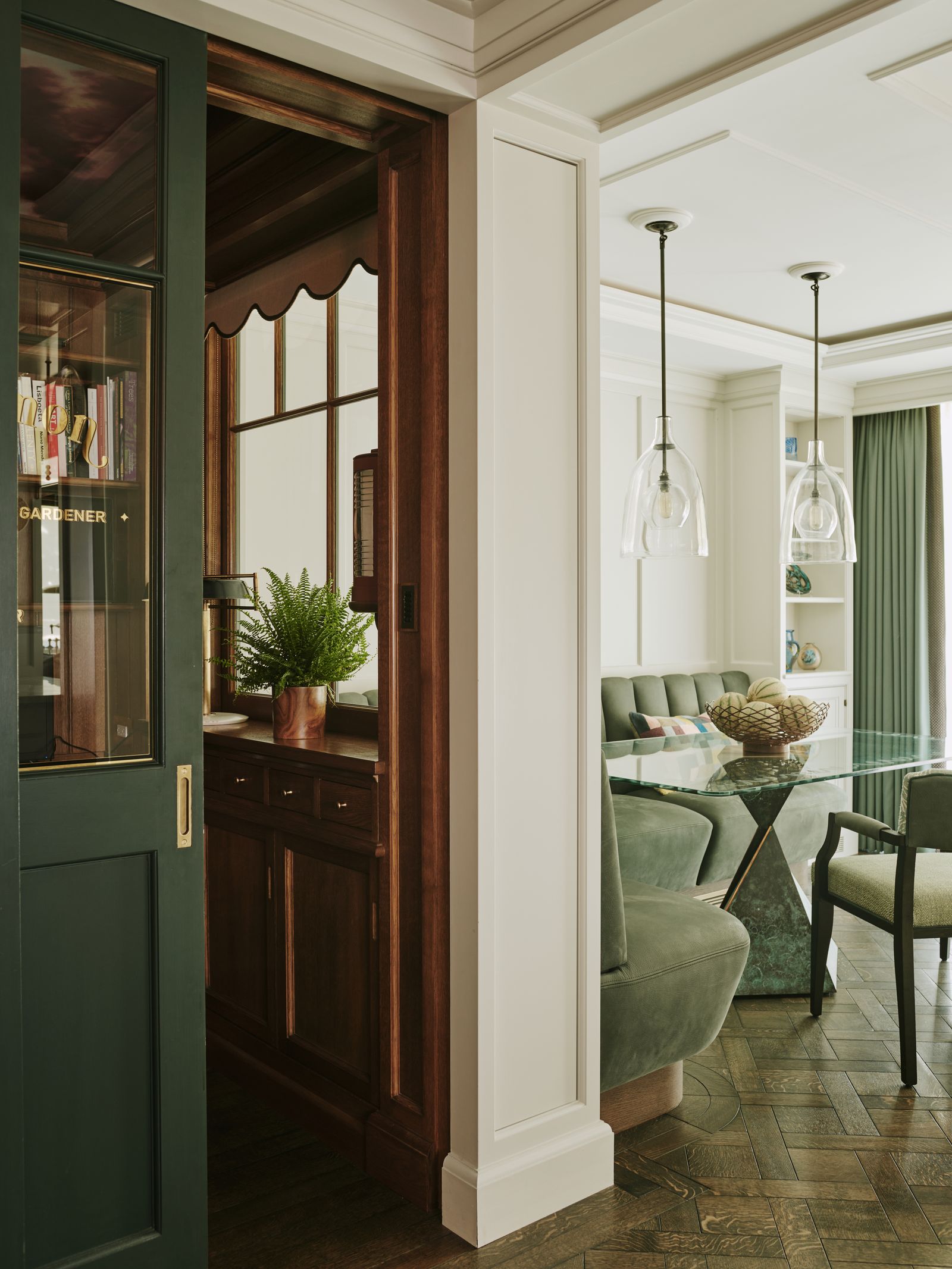 Image may contain Indoors Interior Design Door Plant Lamp Chair Furniture Desk Table Architecture and Building