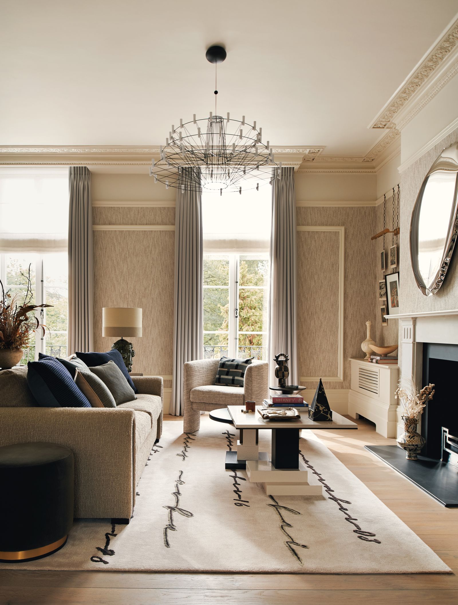 Image may contain Home Decor Lamp Rug Chandelier Plant Architecture Building Furniture Indoors and Living Room