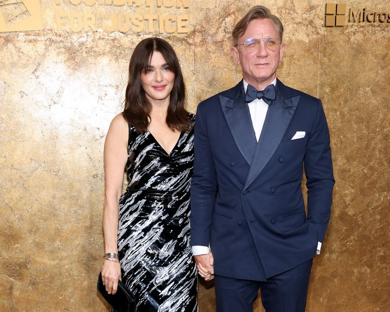 Image may contain: Daniel Craig, Rachel Weisz, Clothing, Formal Wear, Suit, Fashion, Accessories, Tie, Adult, and Person