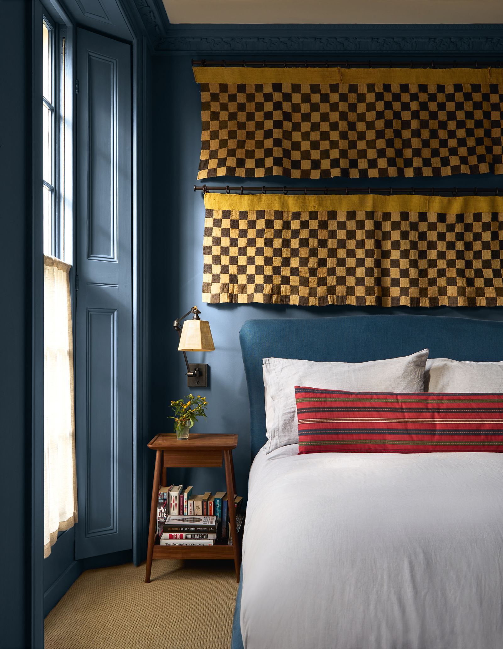 Image may contain Indoors Interior Design Home Decor Cushion Bed Furniture Wood Panels Lamp Pillow and Bedroom