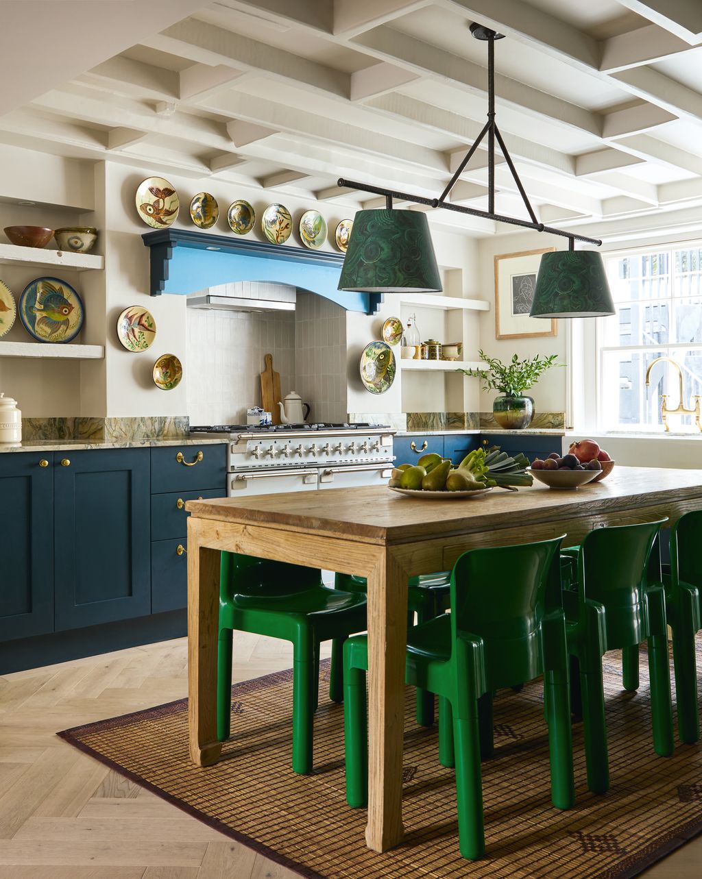 Image may contain Indoors Kitchen Kitchen Island Architecture Building Dining Room Dining Table Furniture and Room
