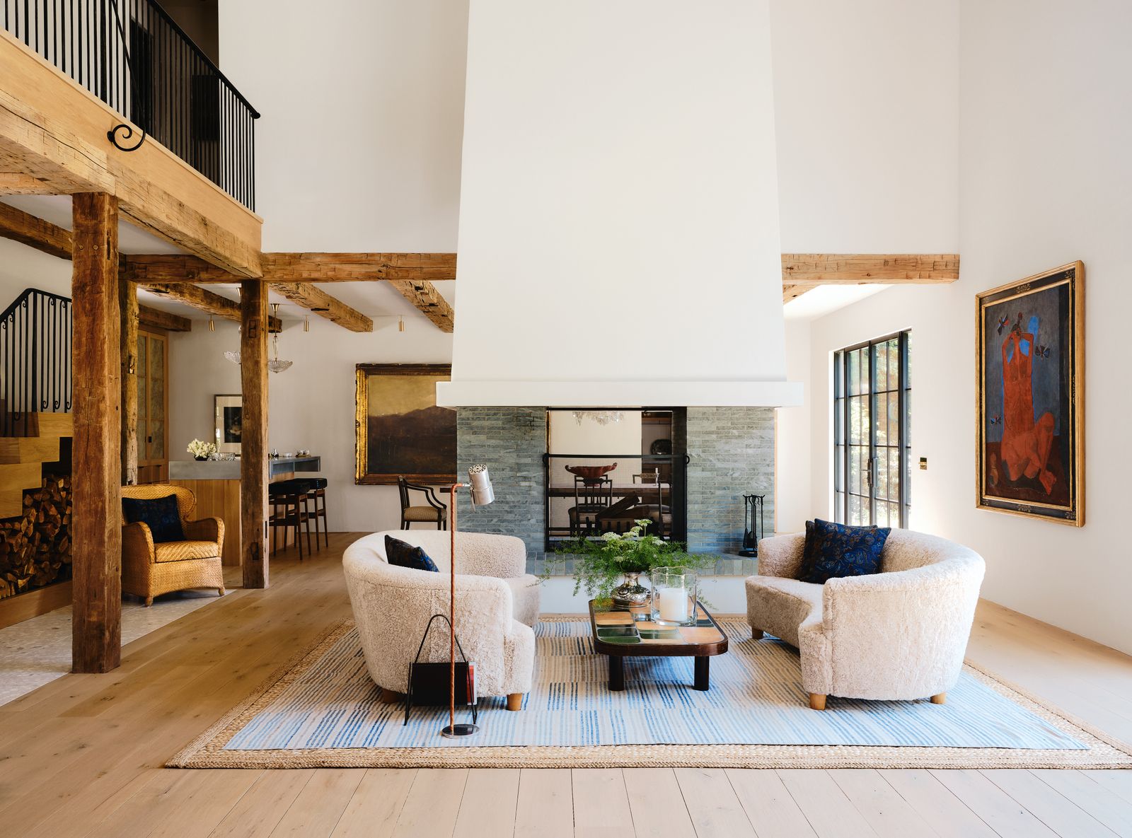 Image may contain Home Decor Architecture Building Furniture Indoors Living Room Room Interior Design Rug and Chair