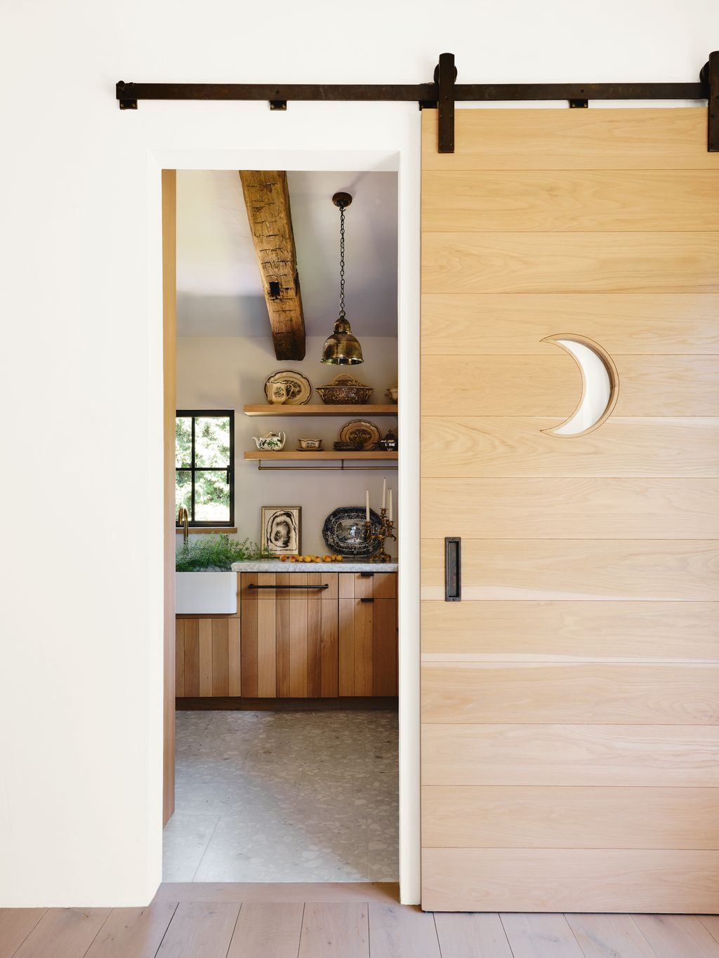 Image may contain Door Sliding Door Indoors Interior Design Lamp Plant Art Painting Wood Plate and Candle