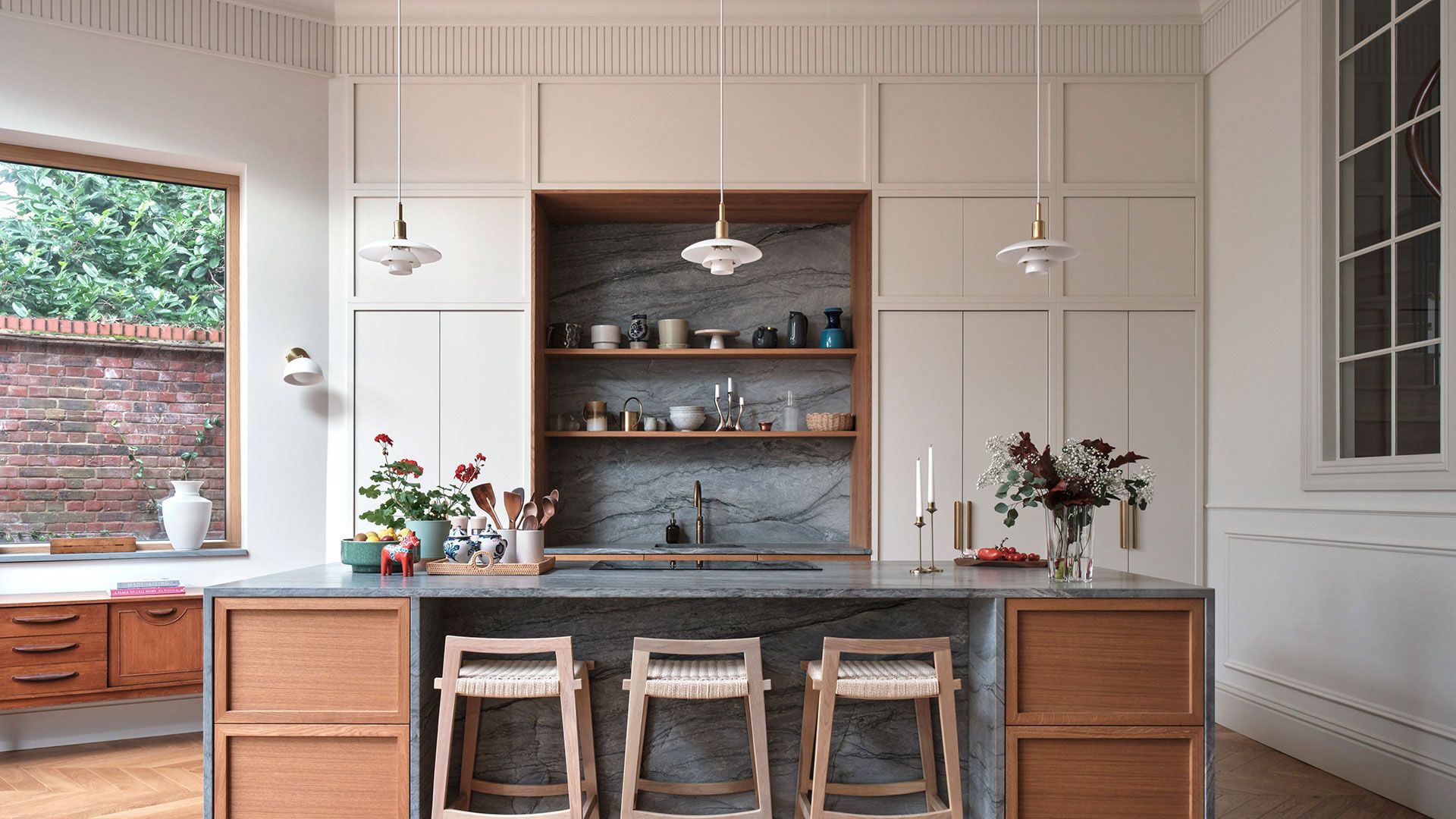 Image may contain: Indoors, Interior Design, Kitchen, Kitchen Island, Cup, Lamp, Furniture, Architecture, and Building