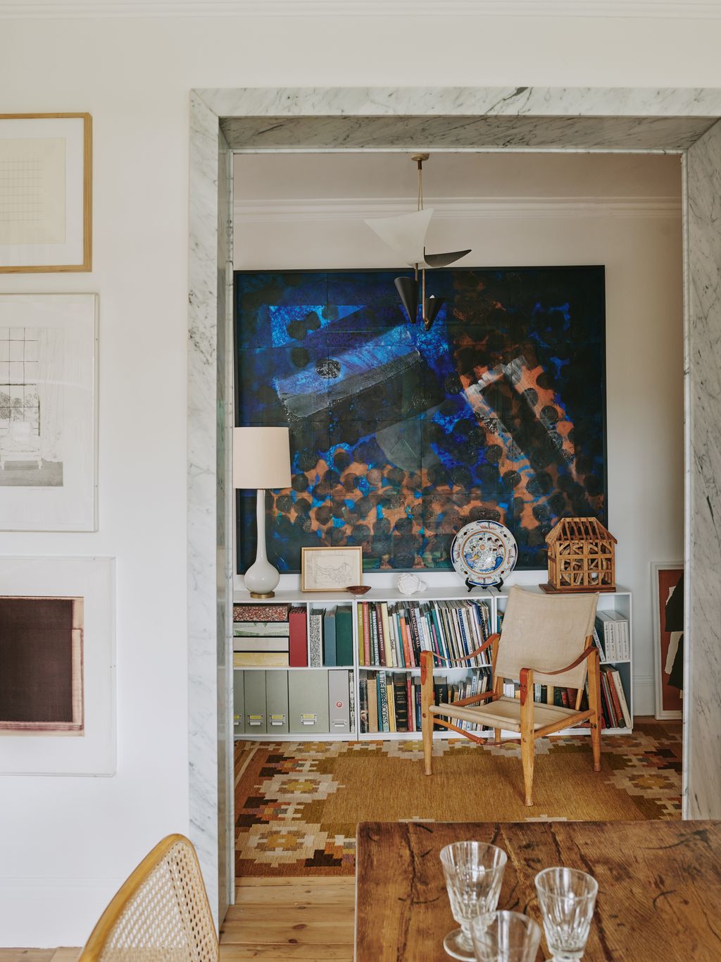 Image may contain Indoors Interior Design Lamp Chair Furniture Cup Home Decor Rug Table Plate Art and Painting