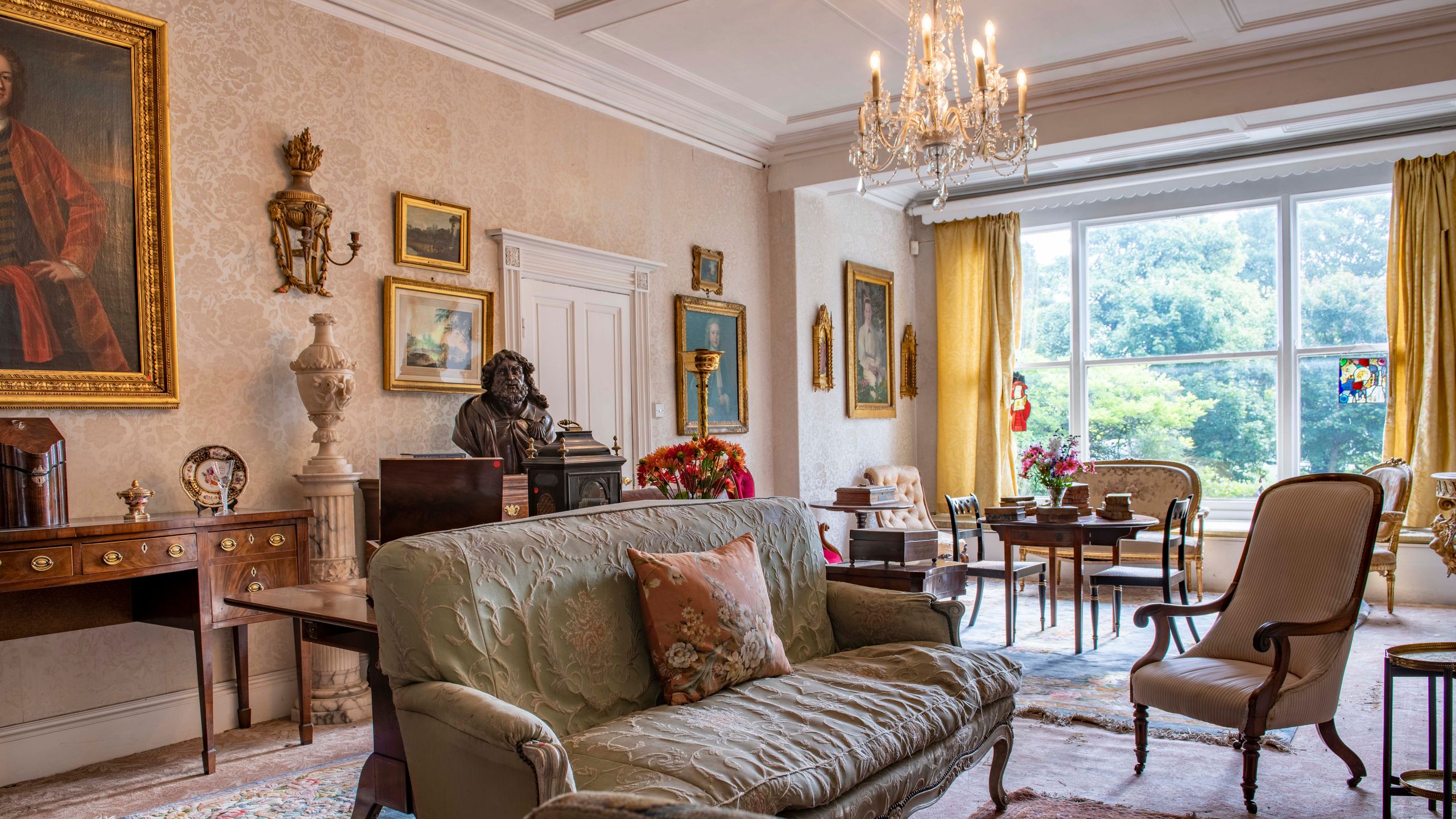 Image may contain: Home Decor, Lamp, Art, Painting, Chair, Furniture, Couch, Rug, Person, Indoors, and Reception