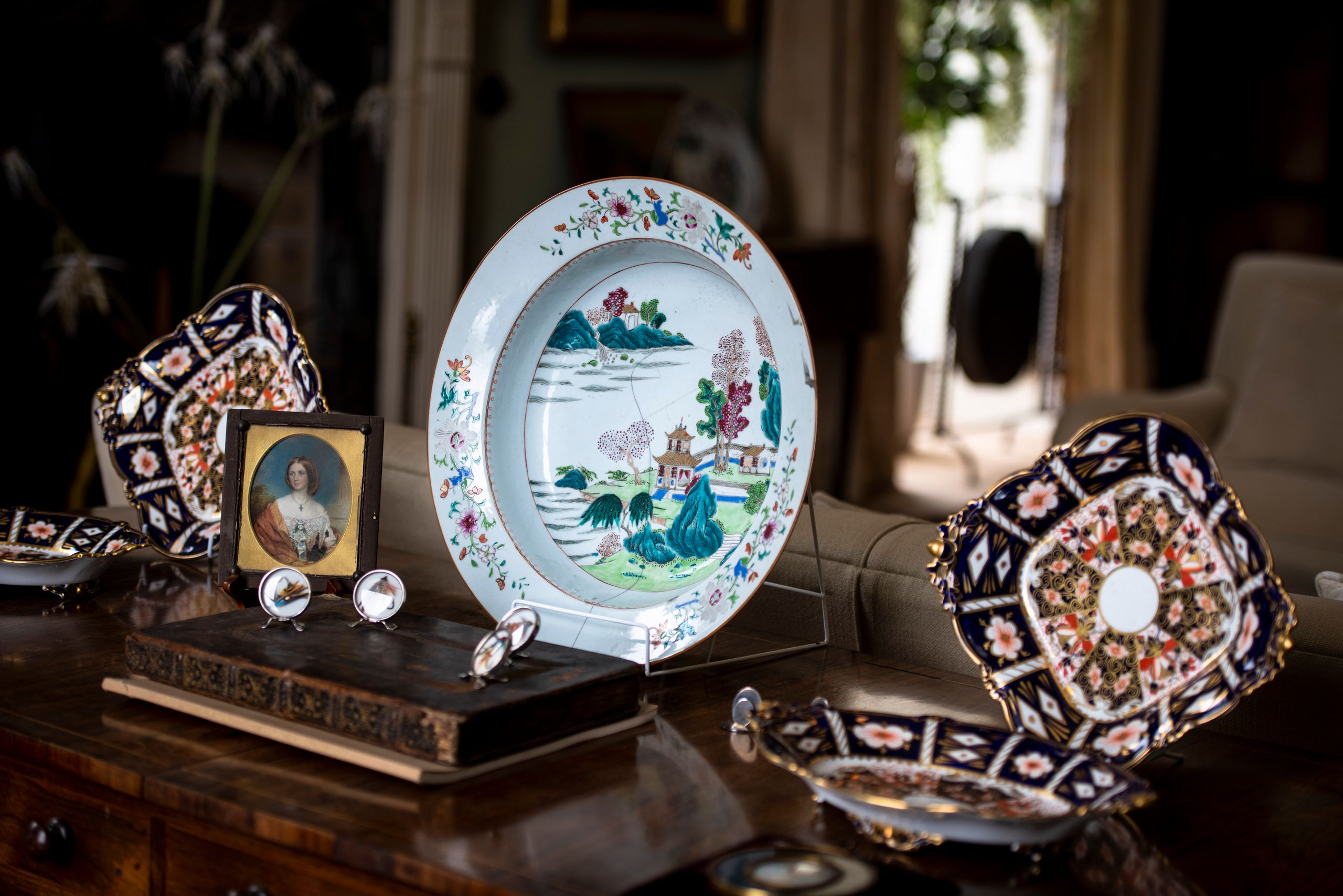 Image may contain: Art, Porcelain, Pottery, Painting, Person, Plate, Accessories, Bag, Handbag, Handicraft, and Desk