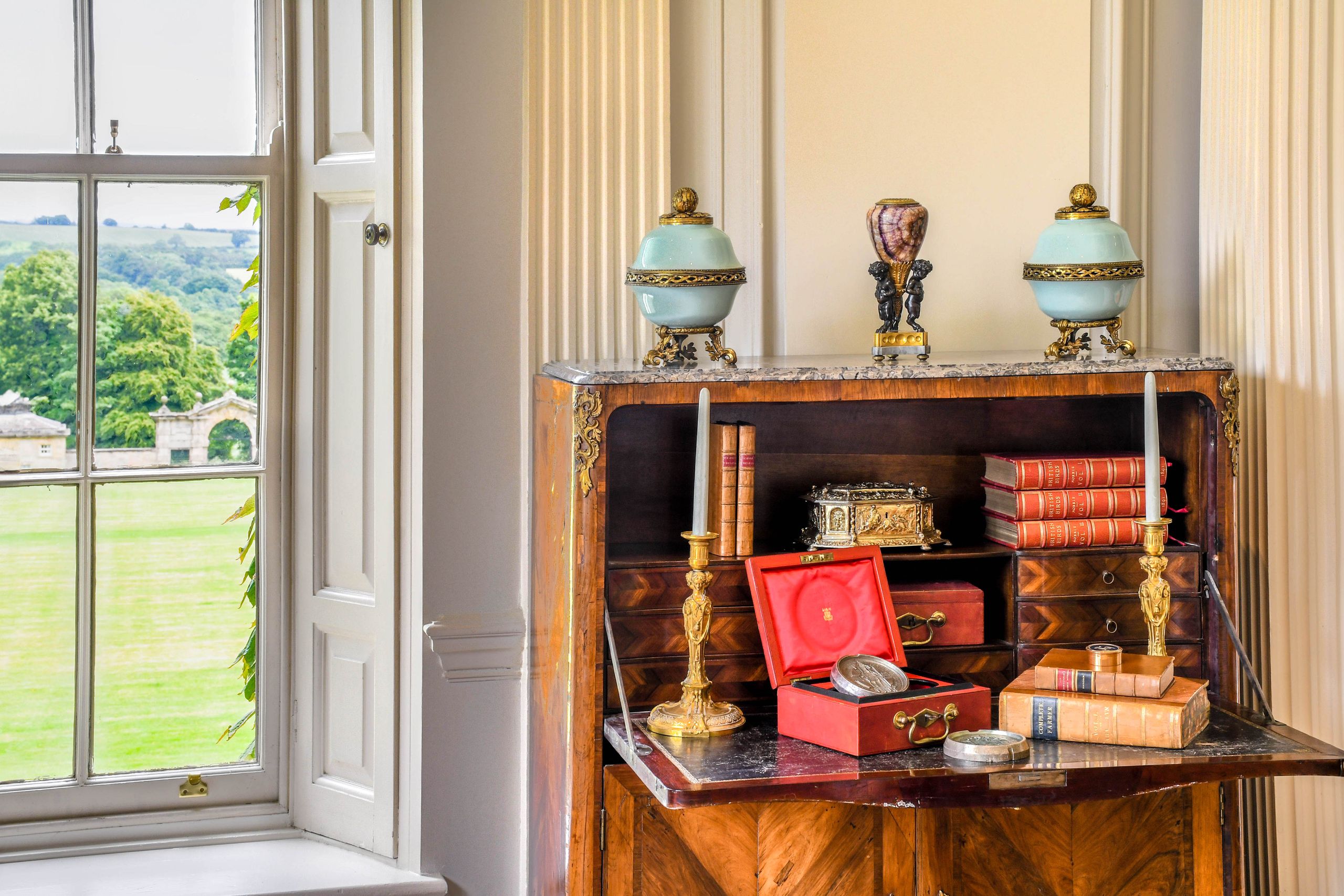 Image may contain: Indoors, Interior Design, Furniture, Table, Box, Sideboard, Candle, Desk, Person, and Cabinet