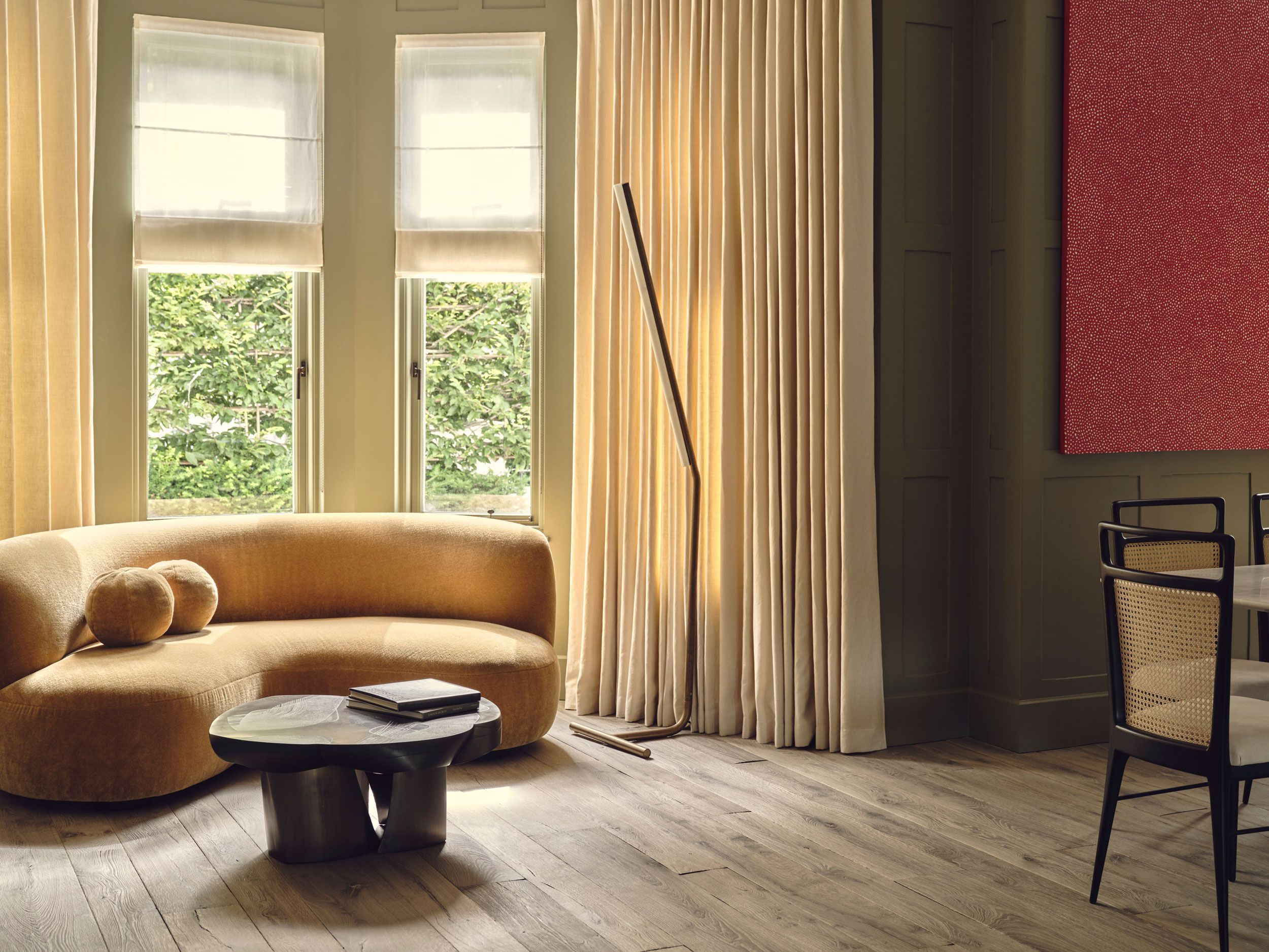 Image may contain: Indoors, Interior Design, Couch, Furniture, Chair, Lamp, Window, Book, and Publication