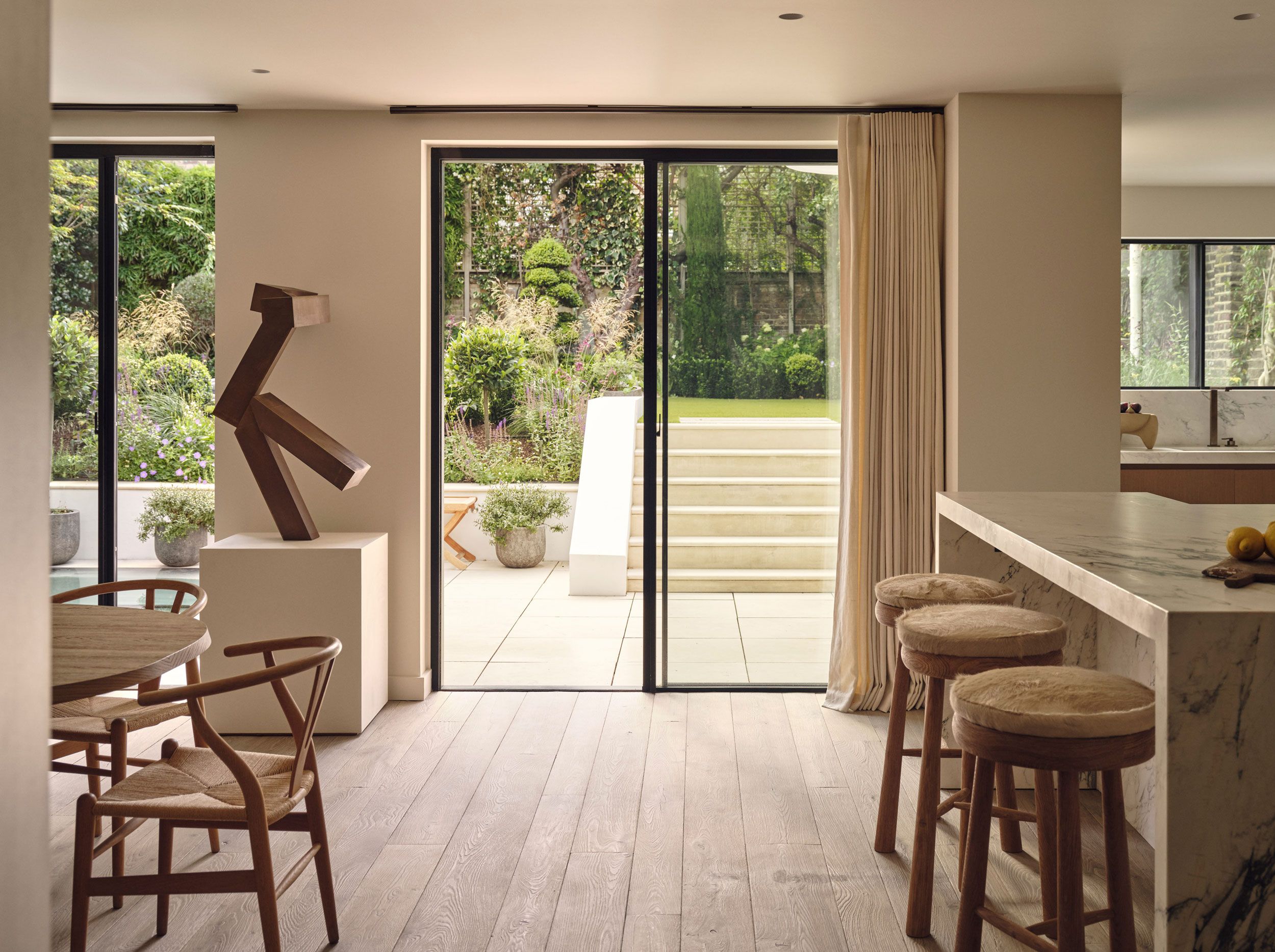 Image may contain: Door, Plant, Indoors, Interior Design, Chair, Furniture, Desk, Table, Architecture, Building, and Housing