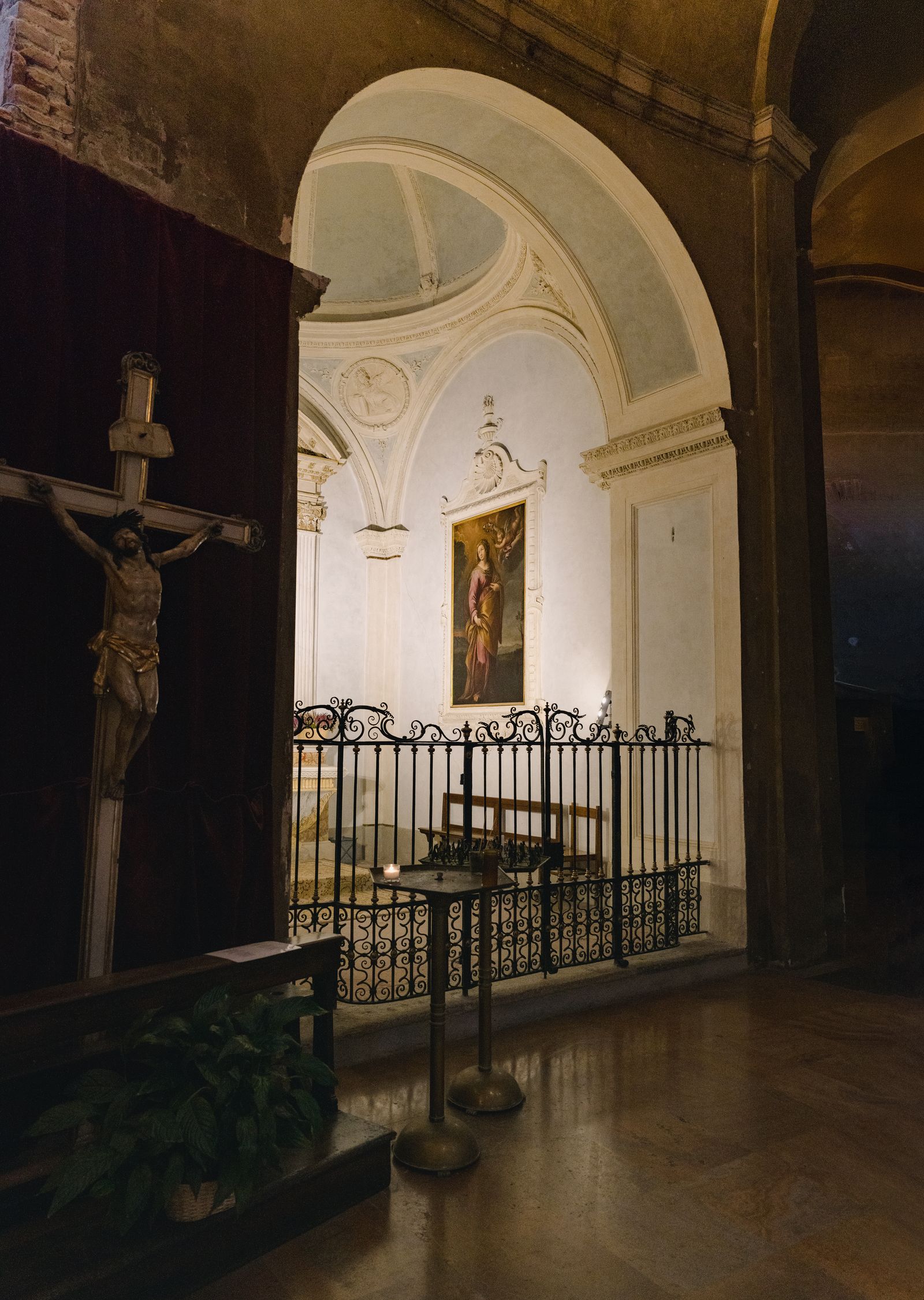 Image may contain Cross Symbol Plant Altar Architecture Building Church Prayer Person Bench Furniture and Adult