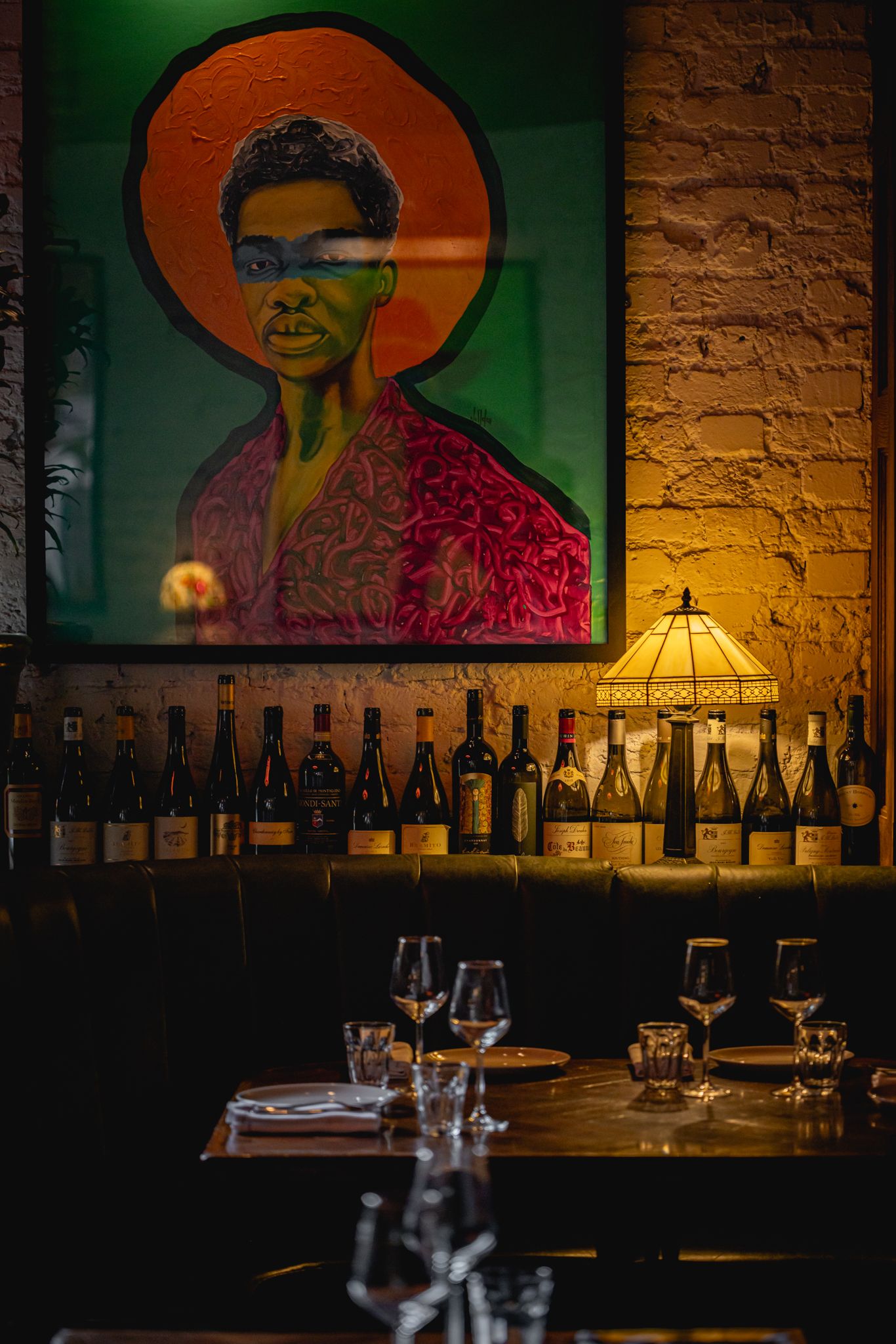 Image may contain Cup Adult Person Plate Pub Lamp Bottle Alcohol Beverage and Liquor