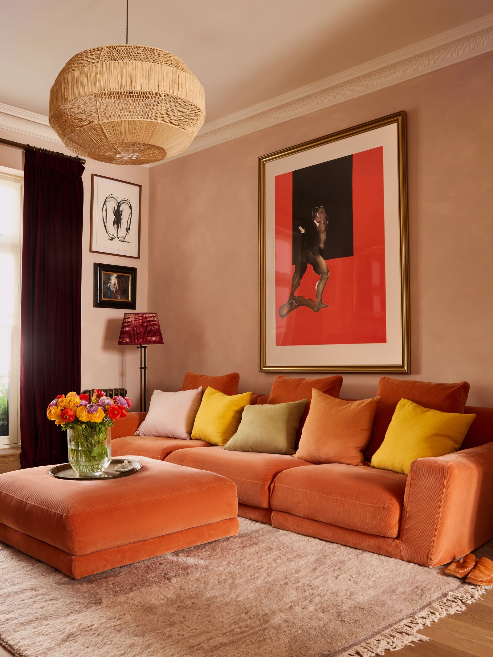 Image may contain Home Decor Furniture Art Painting Rug Lamp Adult Person Clothing Footwear Shoe and Couch