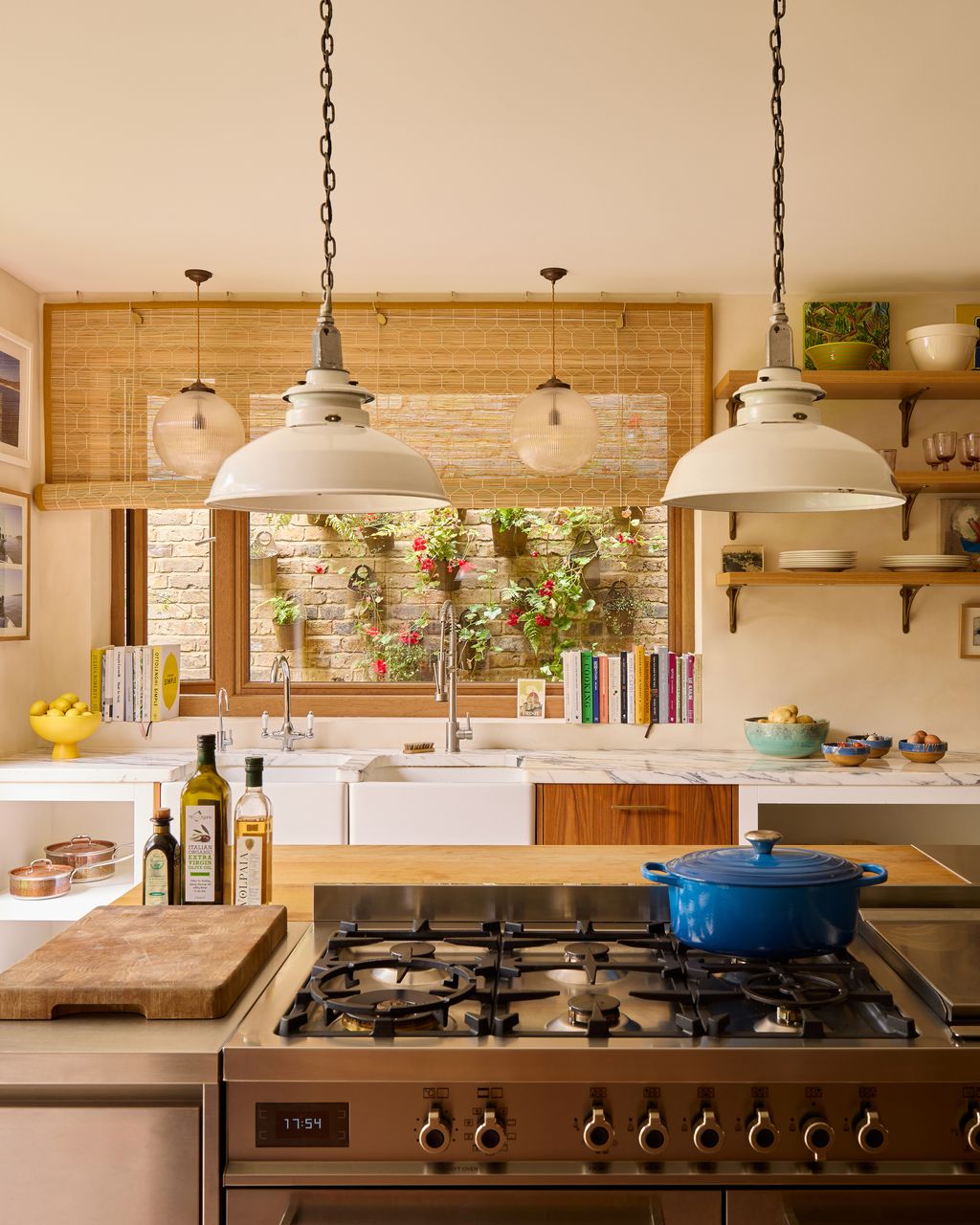 Image may contain Indoors Kitchen Lamp Interior Design Art Painting Plant and Cooktop