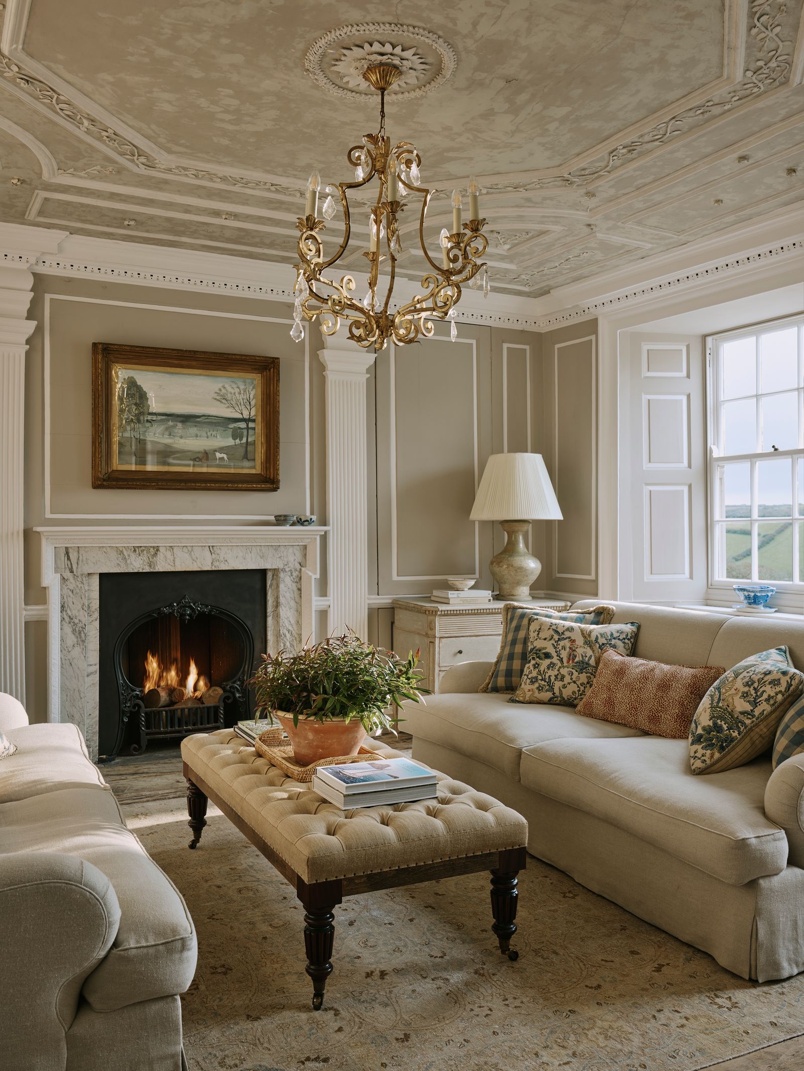 Image may contain Furniture Chandelier Lamp Fireplace Indoors Couch Home Decor Plant and Rug