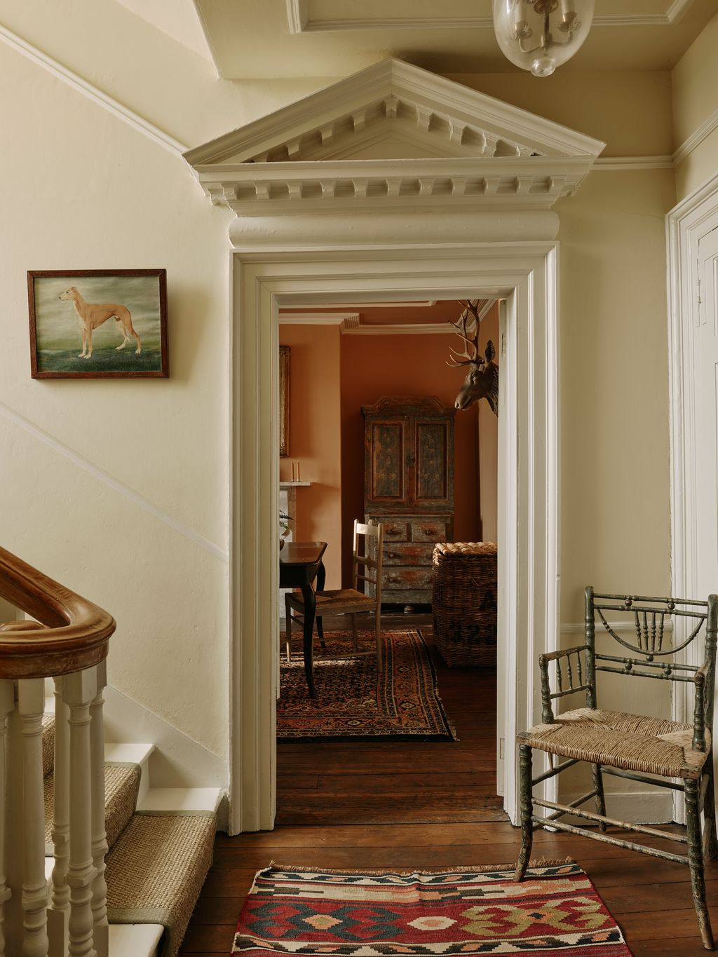 Image may contain Chair Furniture Home Decor Rug Art Painting Indoors Architecture Building Foyer Lamp and Desk