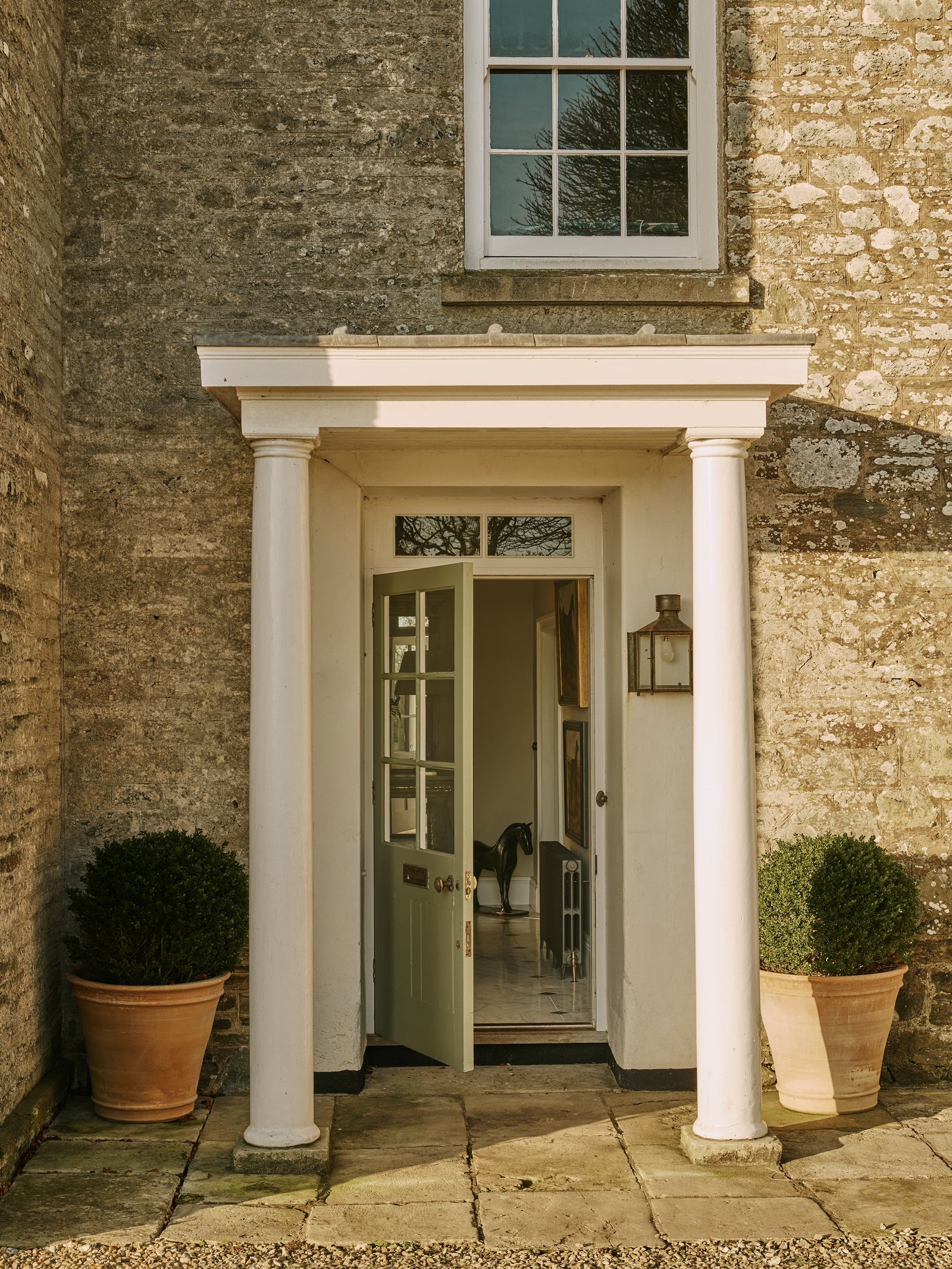 Image may contain Architecture Building Housing House Portico Plant Lamp Animal Horse Mammal Art and Painting