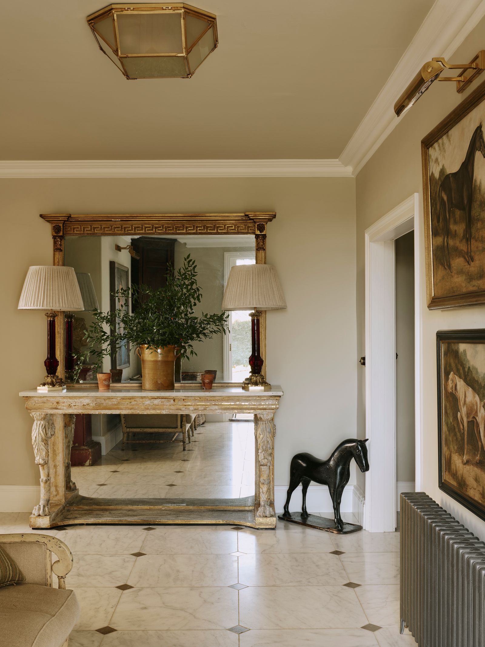 Image may contain Floor Lamp Indoors Interior Design Flooring Plant Art Painting Clothing Footwear Shoe and Desk