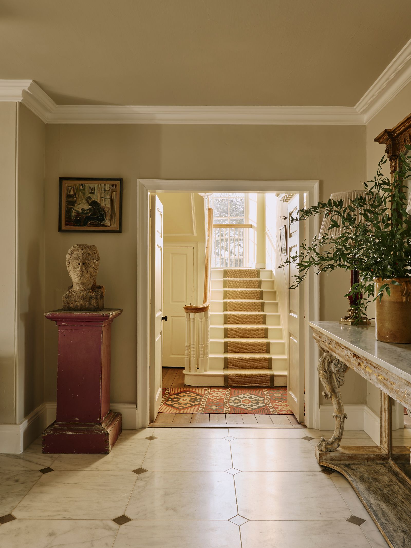 Image may contain Indoors Architecture Building Foyer Floor Person Plant Art Painting Home Decor and Rug