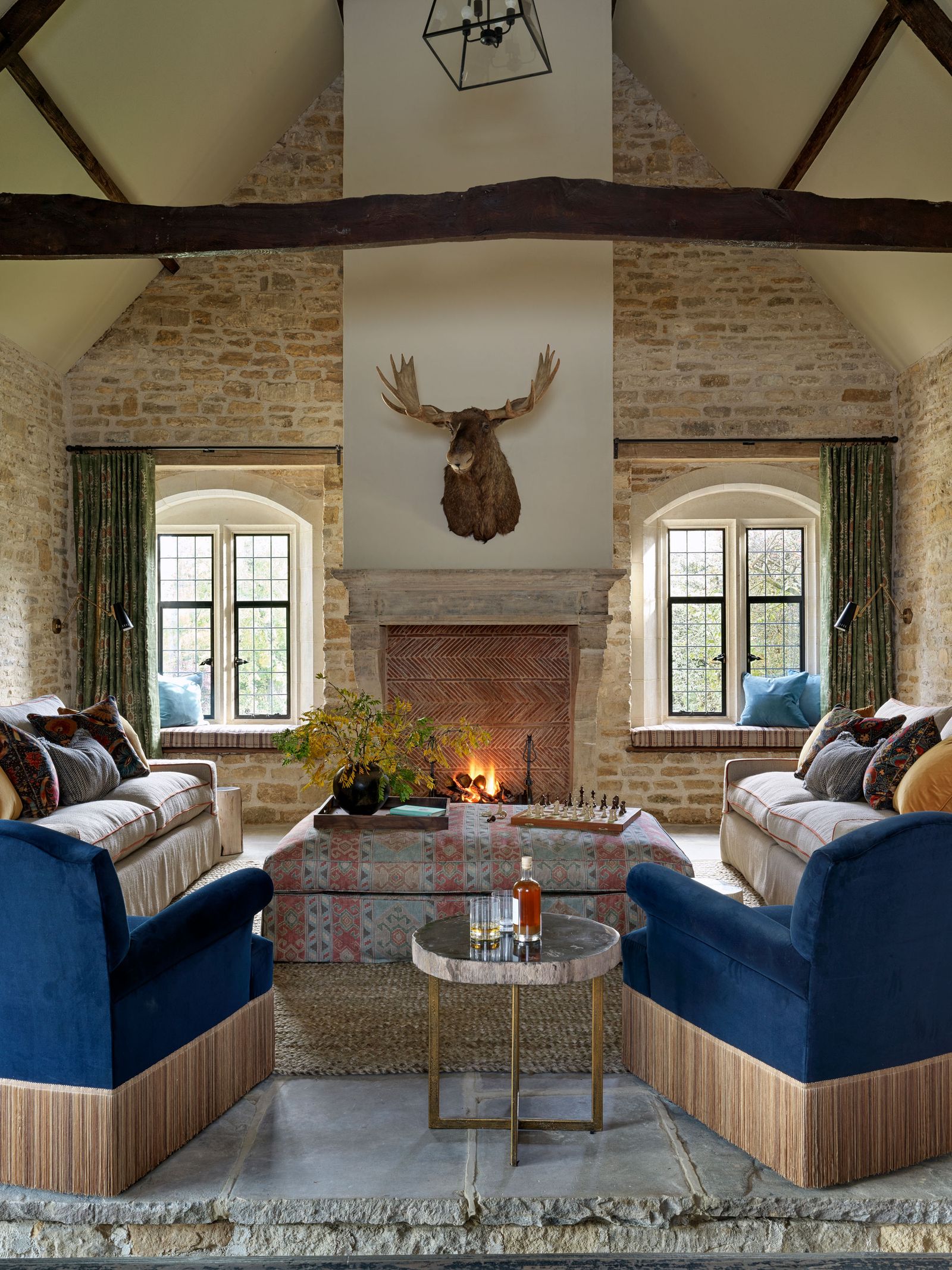 Image may contain Plant Architecture Building Furniture Indoors Living Room Room Couch Home Decor and Fireplace