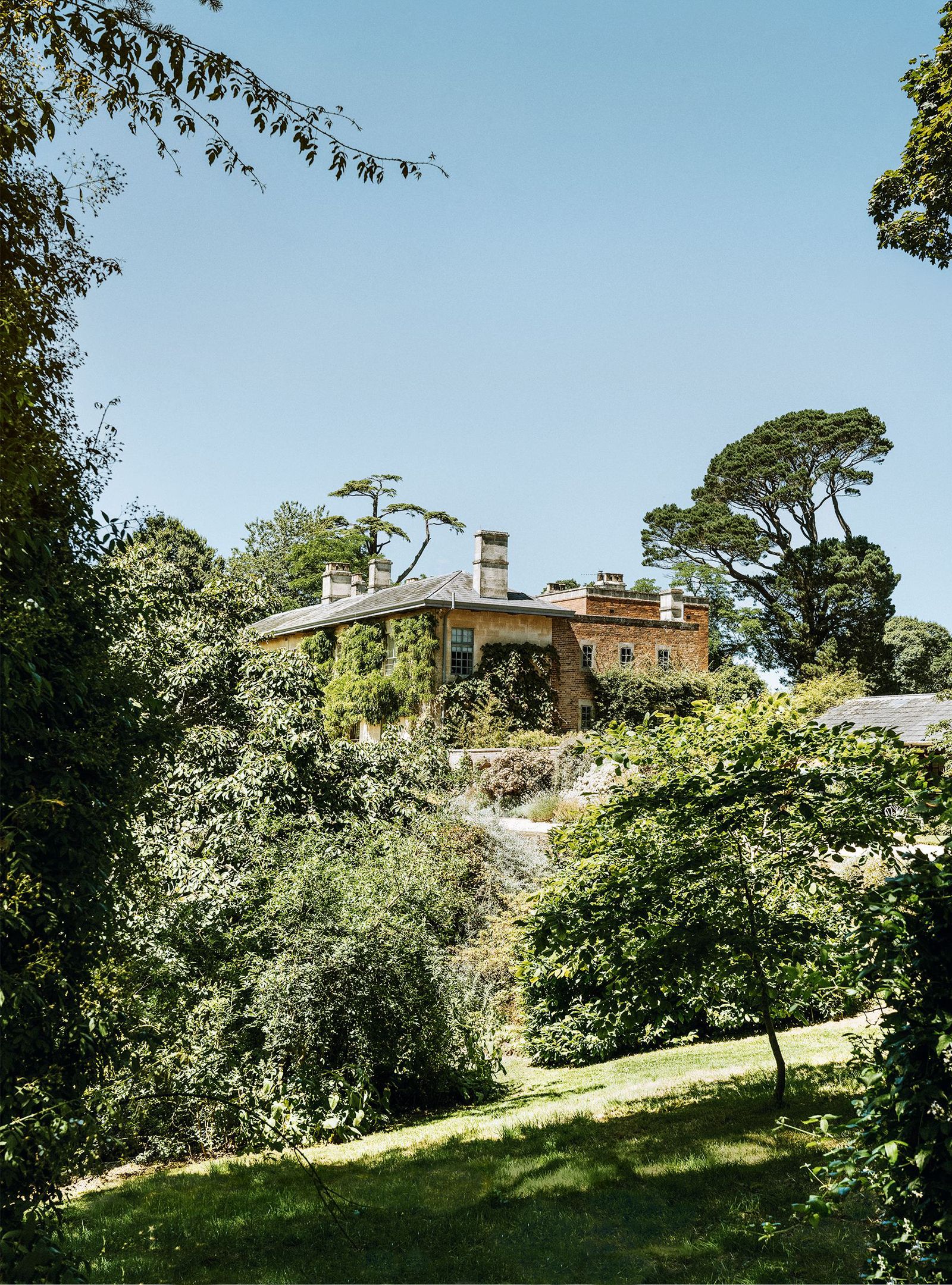 Image may contain Architecture Building Cottage House Housing Plant Vegetation Tree Land Nature and Outdoors