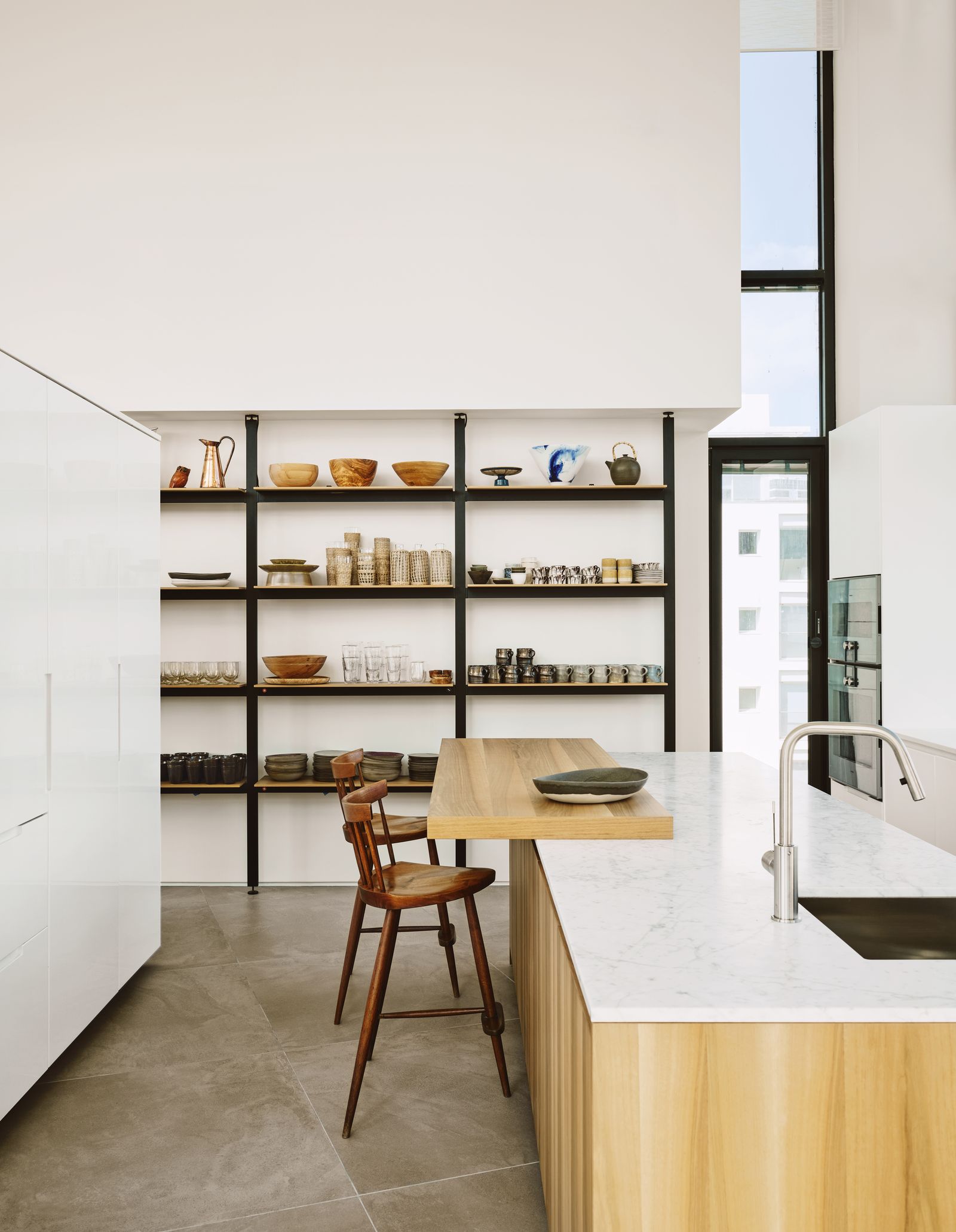 Image may contain Indoors Interior Design Shelf Sink Chair Furniture Sink Faucet Kitchen Plate Pantry and Floor