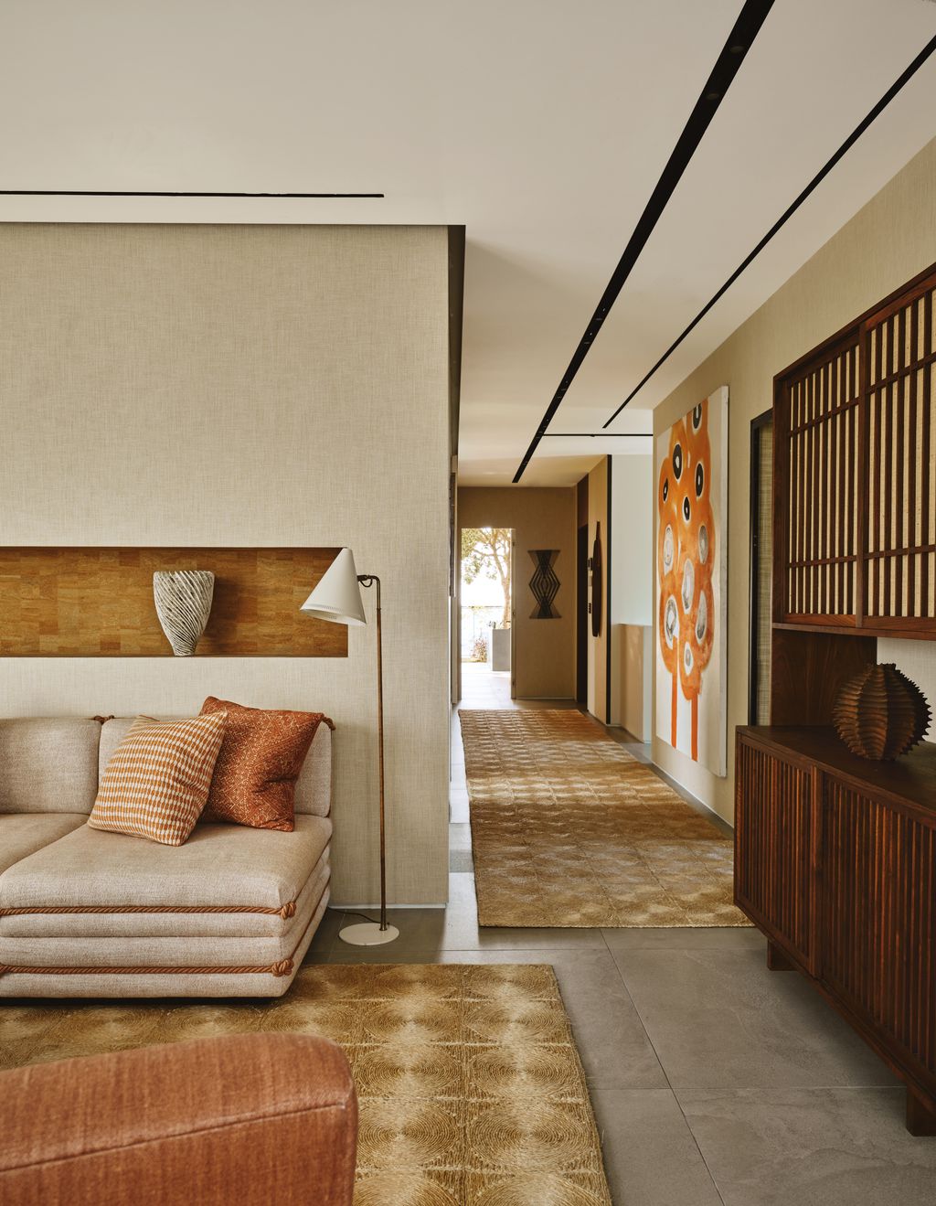 Image may contain Home Decor Indoors Interior Design Lamp Rug Floor Couch Furniture Architecture and Building