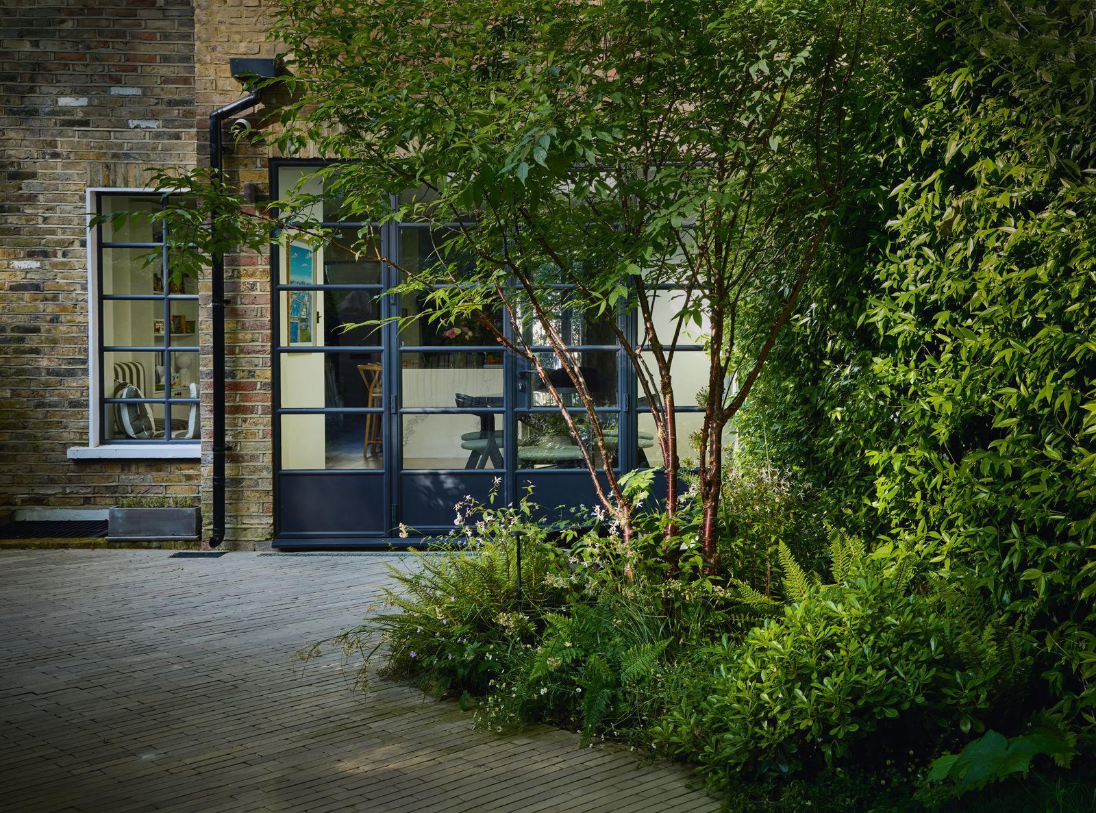 Image may contain Door Indoors Interior Design Plant Vegetation Architecture Building Housing Person and House