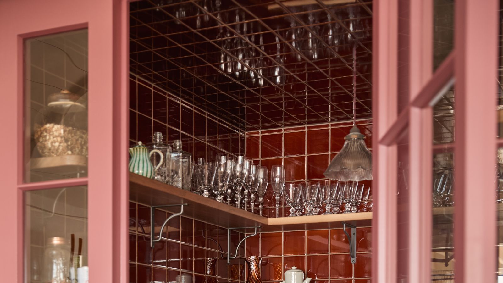 Image may contain: Indoors, Interior Design, Lamp, Shelf, Cabinet, Furniture, China Cabinet, Cup, Sink, and Sink Faucet