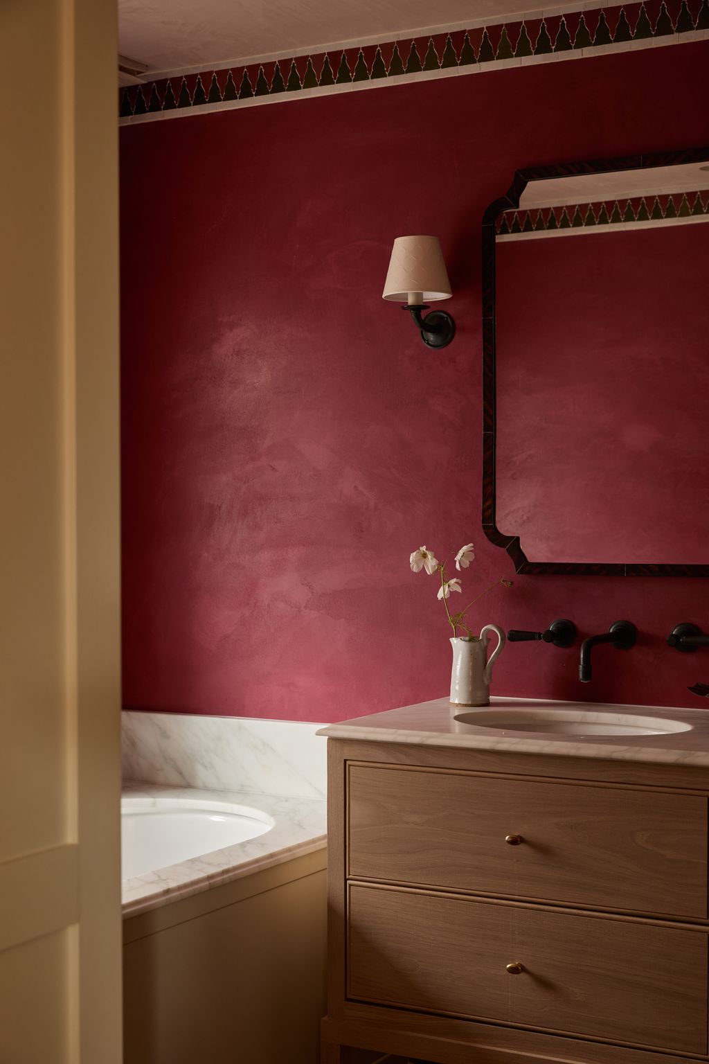 Image may contain Indoors Interior Design Sink Lamp Sink Faucet Bathing Bathtub Person and Tub