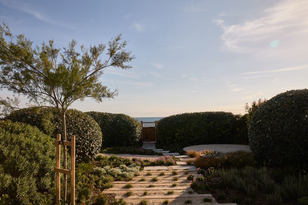 Image may contain Fence Hedge Plant Garden Nature Outdoors Vegetation Scenery Path Landscape Grass Tree and Park