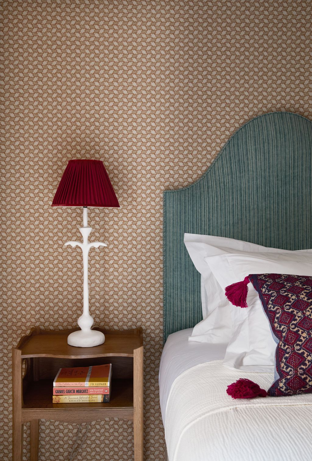 Image may contain Lamp Cushion Home Decor Book Publication Bed Furniture Table Lamp Indoors and Interior Design