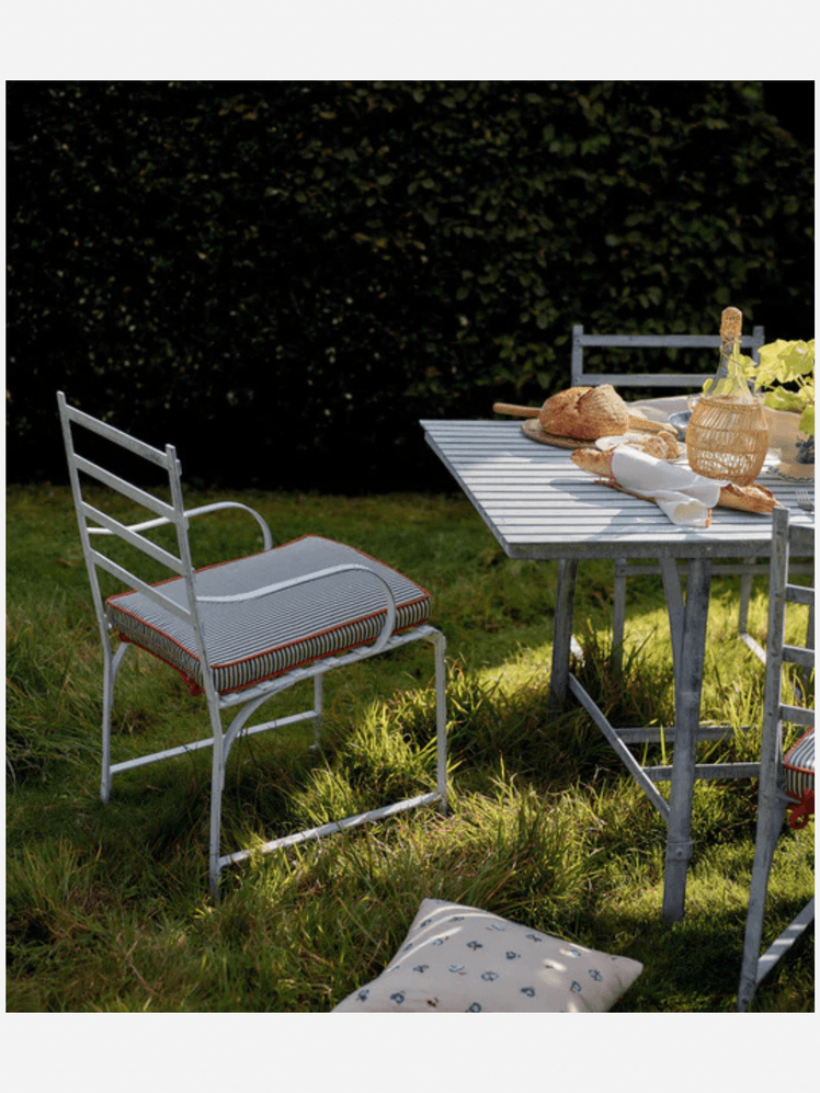 Image may contain: Grass, Plant, Chair, Furniture, Lawn, Dining Table, Table, Indoors, and Interior Design