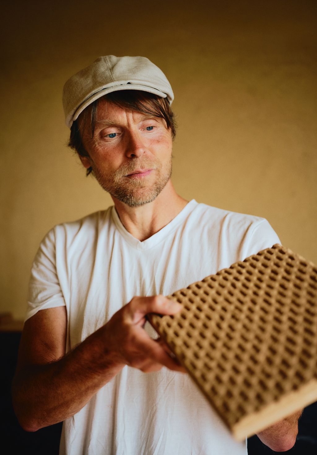 Image may contain Adult Person Face Head Photography Portrait Clothing Hat Indoors Interior Design and Body Part