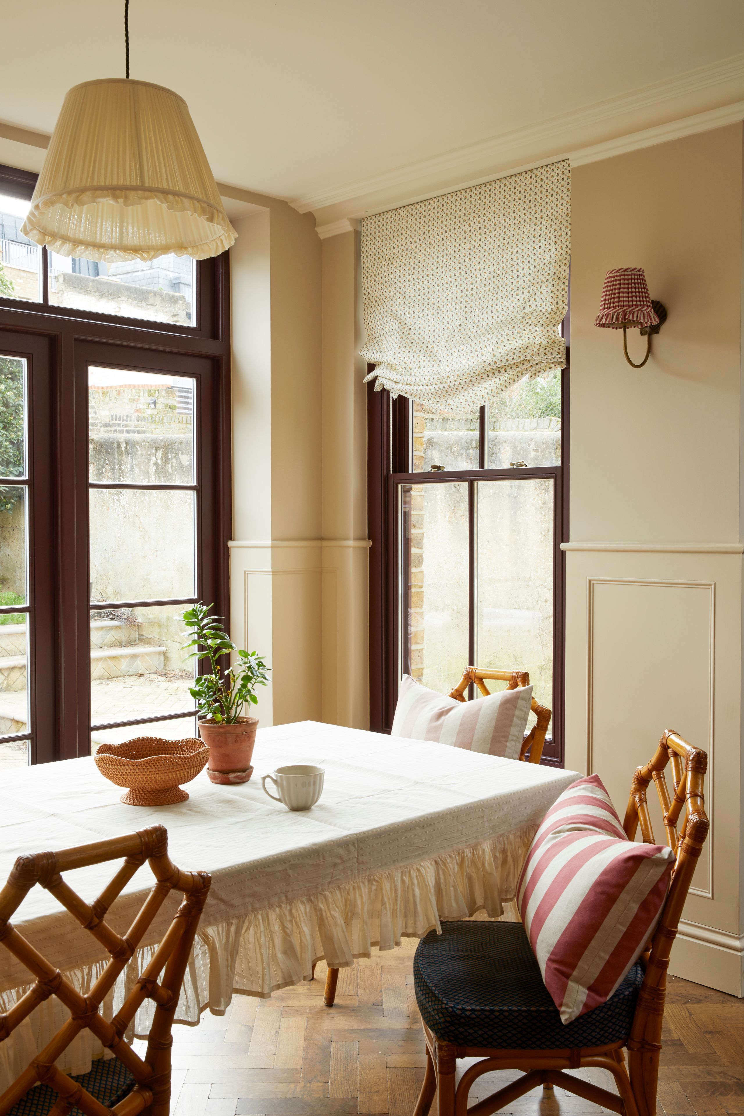 Image may contain: Chair, Furniture, Plant, Lamp, Cup, Dining Table, Table, Architecture, Building, Dining Room, and Indoors