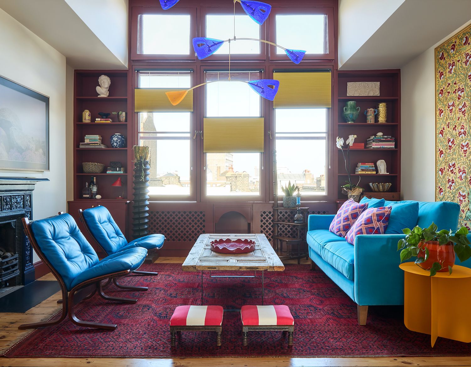 Image may contain Home Decor Architecture Building Furniture Indoors Living Room Room Rug Chair Couch and Plant