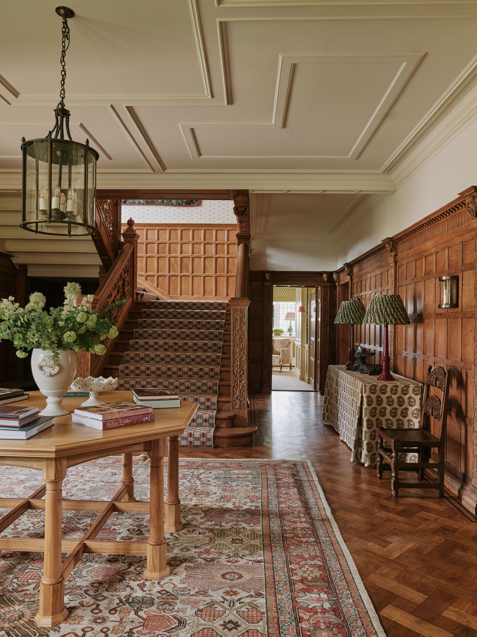 Image may contain Indoors Interior Design Chair Furniture Lamp Book Publication Architecture Building and Foyer