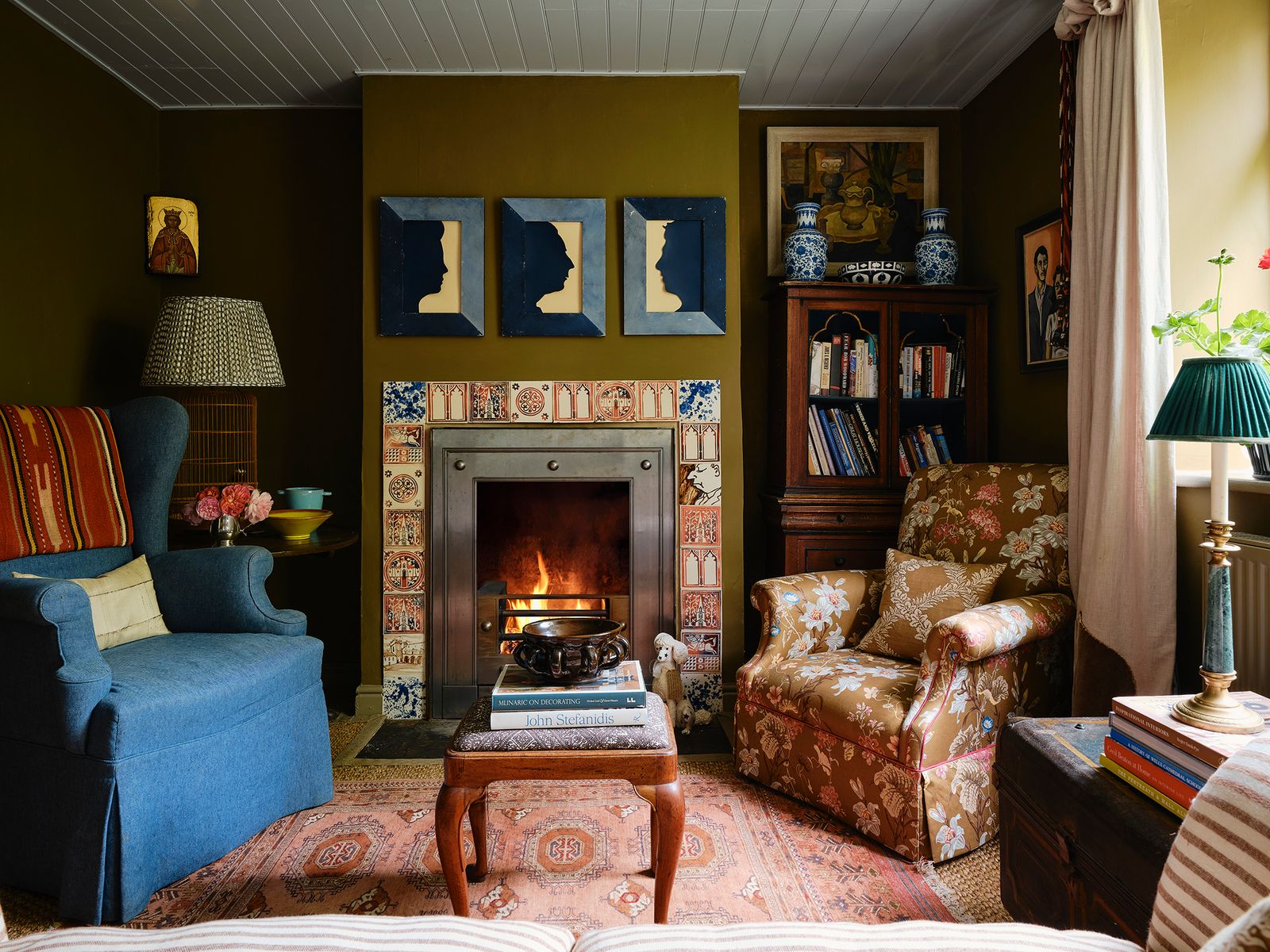 Image may contain Home Decor Lamp Fireplace Indoors Art Painting Couch Furniture Person Architecture and Building