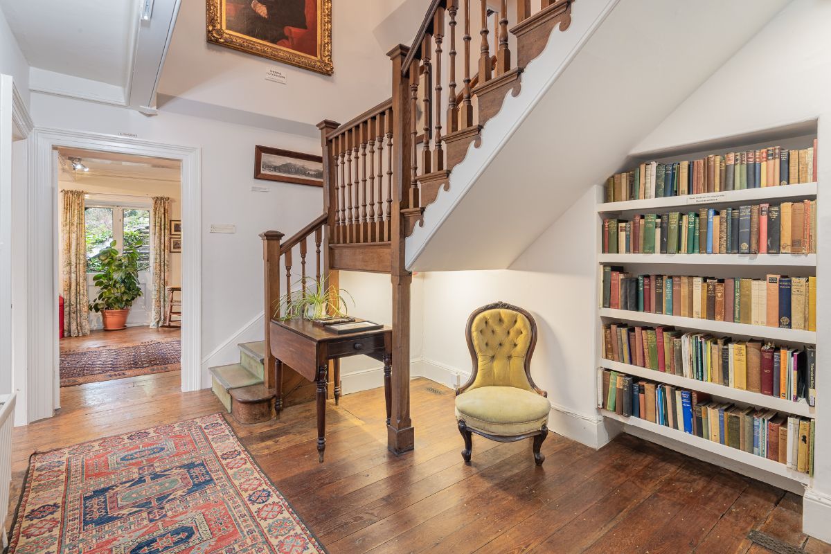 Image may contain Chair Furniture Home Decor Rug Plant Desk Table Art Painting Indoors Architecture and Building