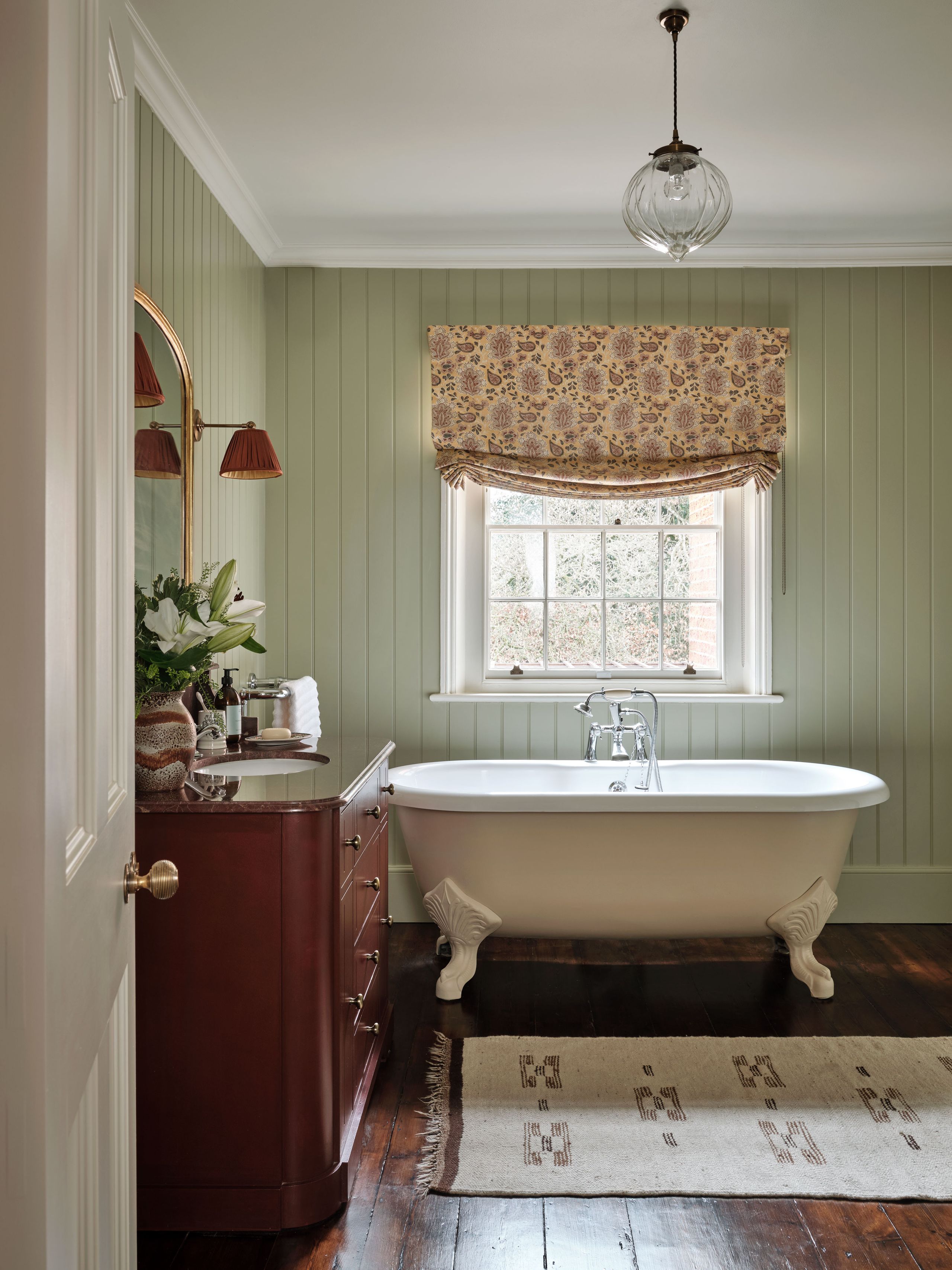 Image may contain: Indoors, Interior Design, Bathing, Home Decor, Rug, Bathtub, Person, Tub, Sink, Sink Faucet, and Plant