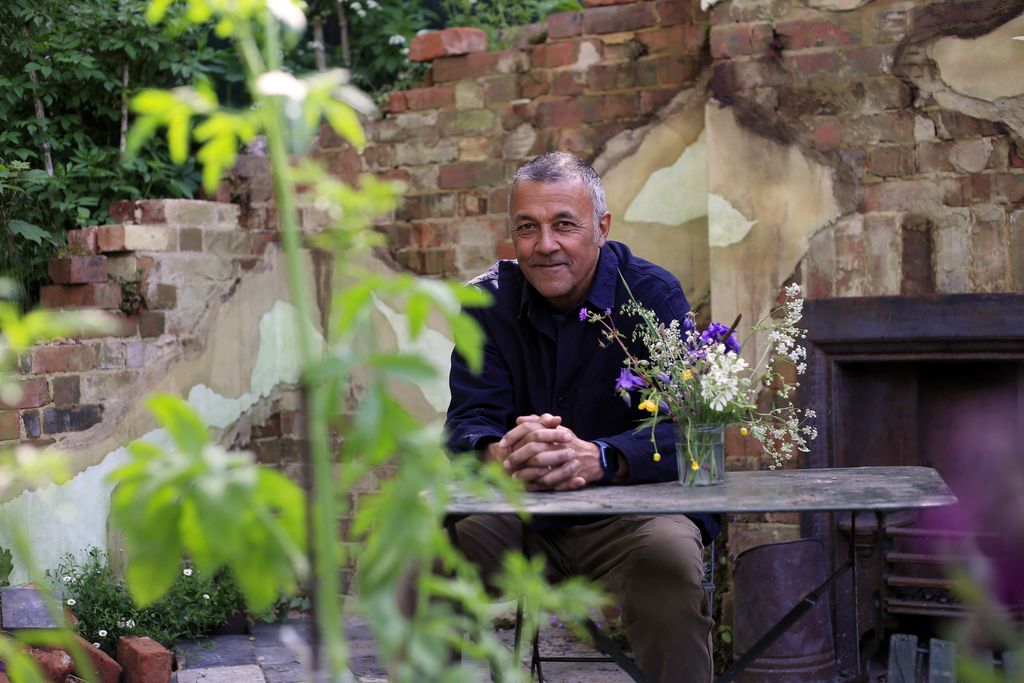 Image may contain Garden Nature Outdoors Adult Person Sitting Senior Citizen Flower Flower Arrangement and Plant