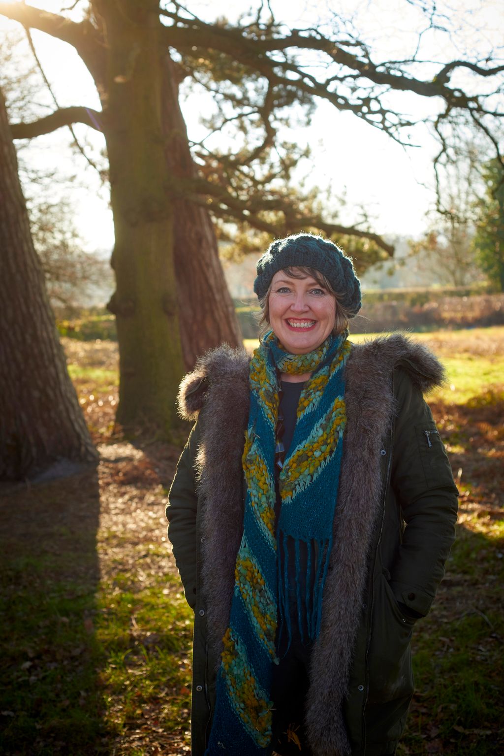 Image may contain Plant Tree Vegetation Clothing Coat Grove Land Nature Outdoors Woodland Face Head and Person