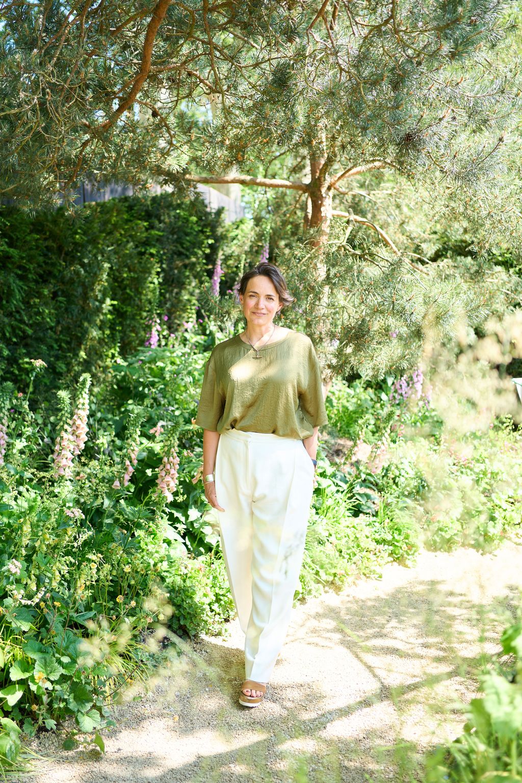 Image may contain Plant Vegetation Person Standing Adult Land Nature Outdoors Tree Woodland Garden and Grove