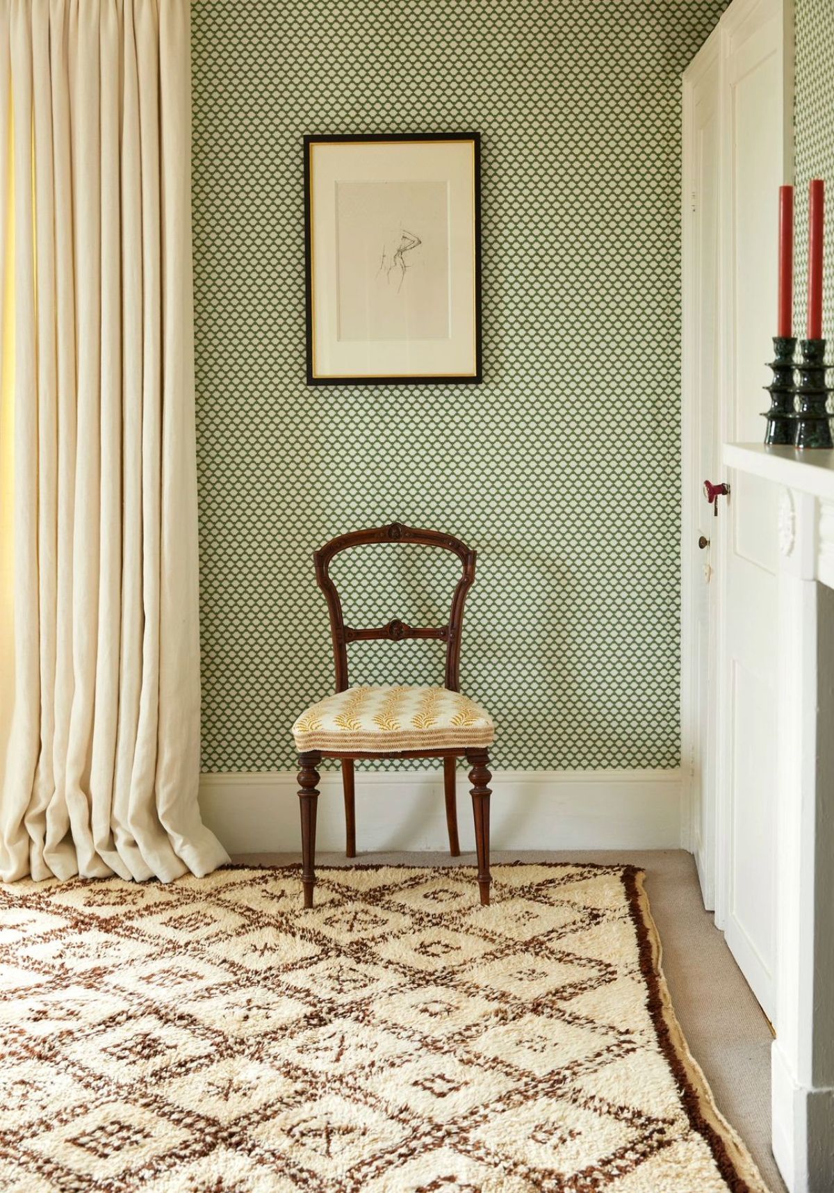 Image may contain: Home Decor, Rug, Chair, Furniture, Indoors, Interior Design, Floor, Candle, Art, and Painting