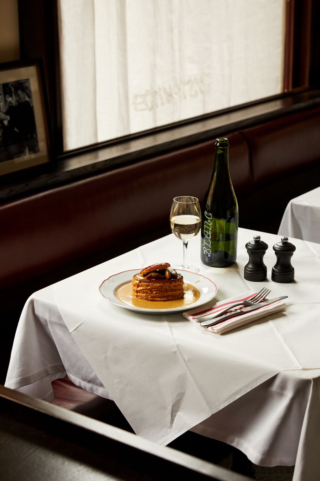 Image may contain Furniture Table Tablecloth Tabletop Plate Art Painting Dining Table Cutlery Fork and Adult