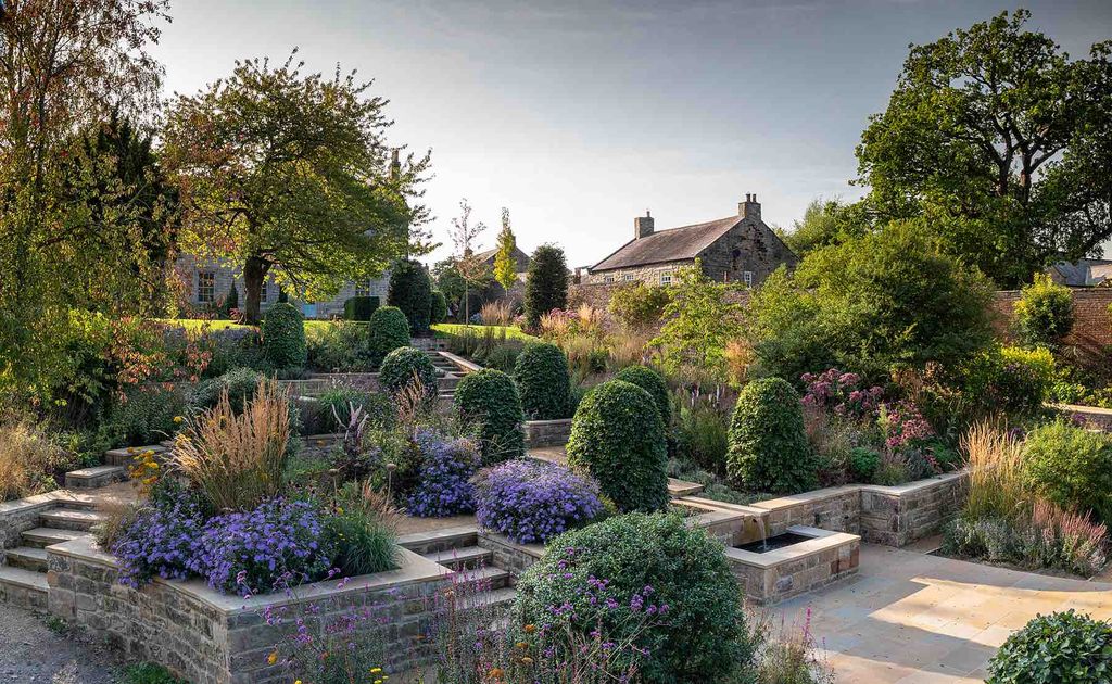 Image may contain Garden Nature Outdoors Grass Plant Park Vegetation Architecture Building Housing and Backyard