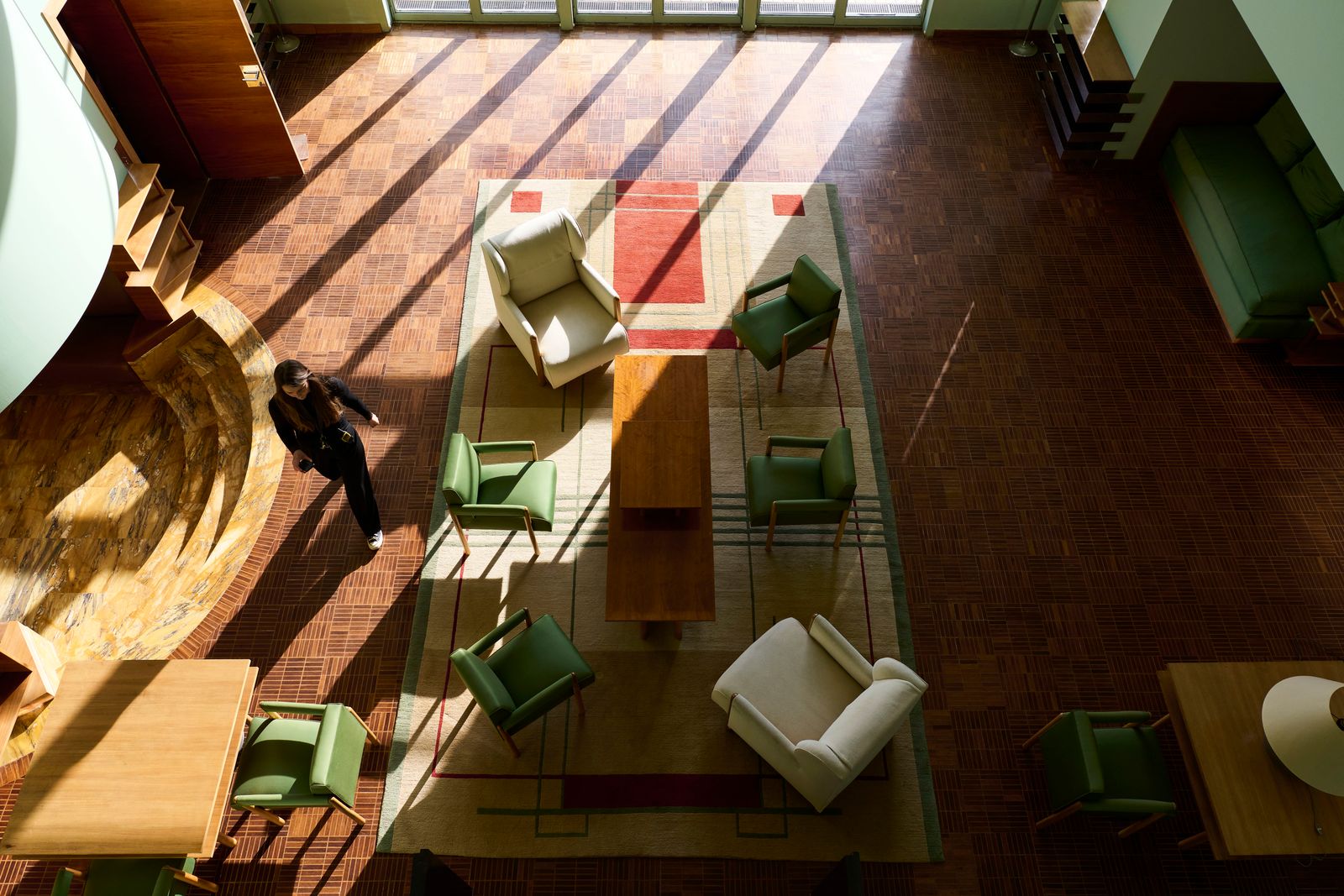 Image may contain Person Chair Furniture Indoors Desk Table Clothing Footwear Shoe Glove and Interior Design