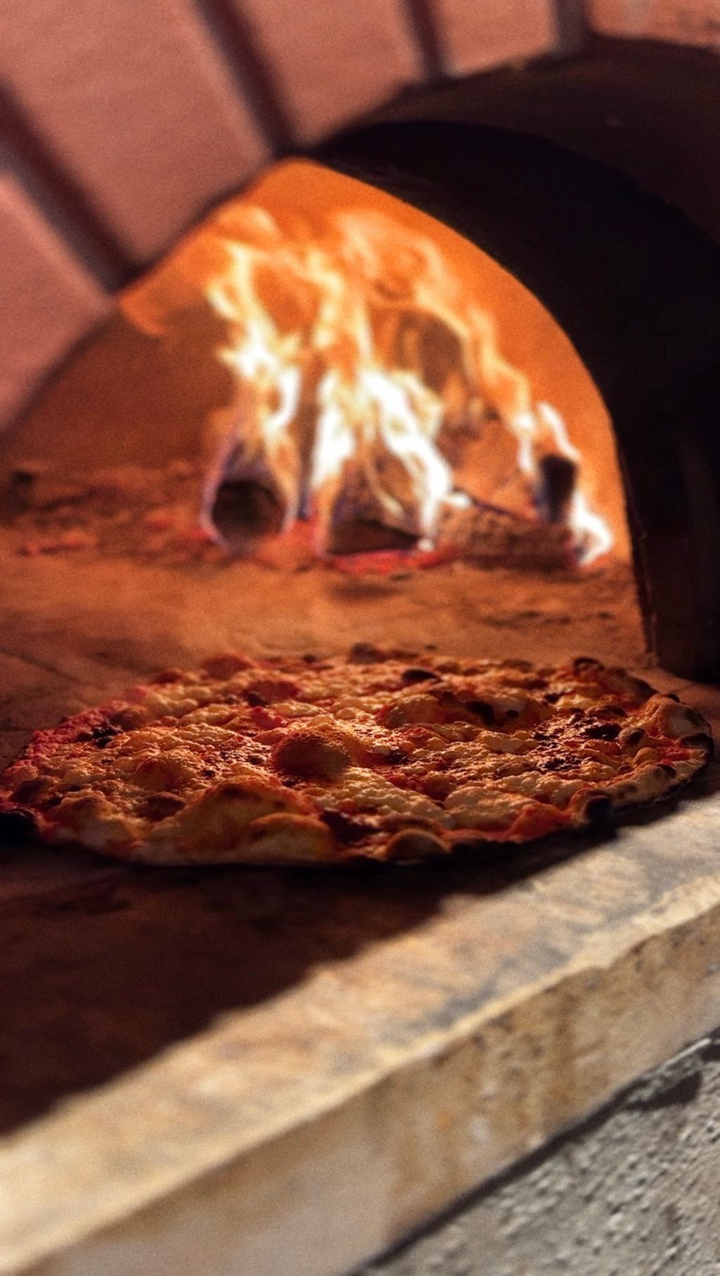 Image may contain Fireplace Indoors Food Pizza Appliance Baking Cooking Device Electrical Device and Oven