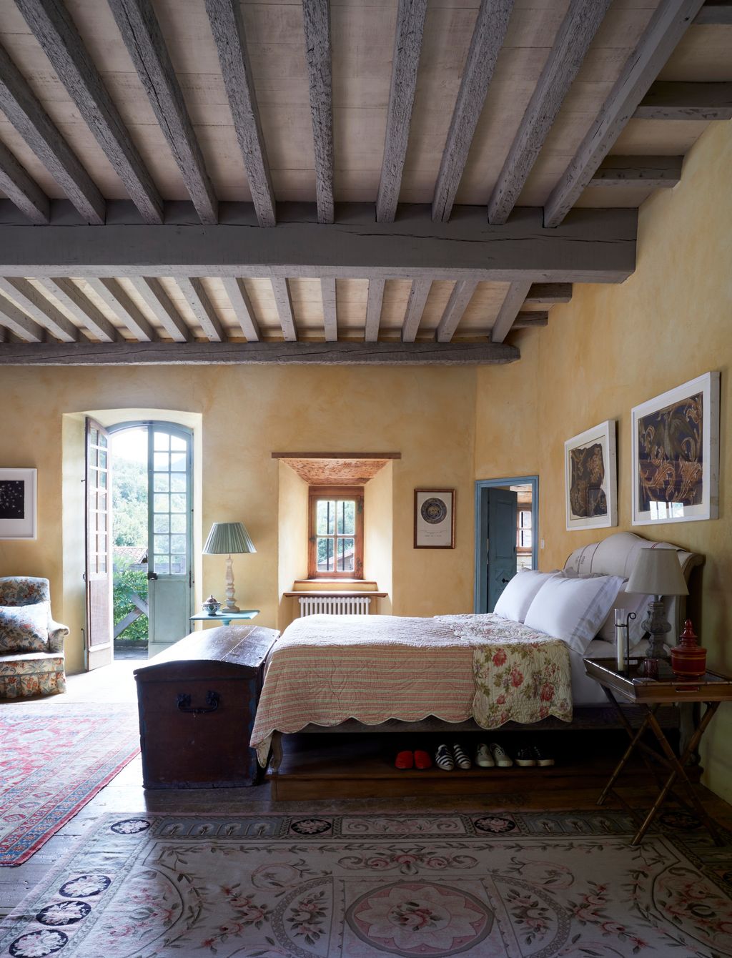 Image may contain Lamp Indoors Interior Design Home Decor Bed Furniture Art Painting Desk Table Door and Rug