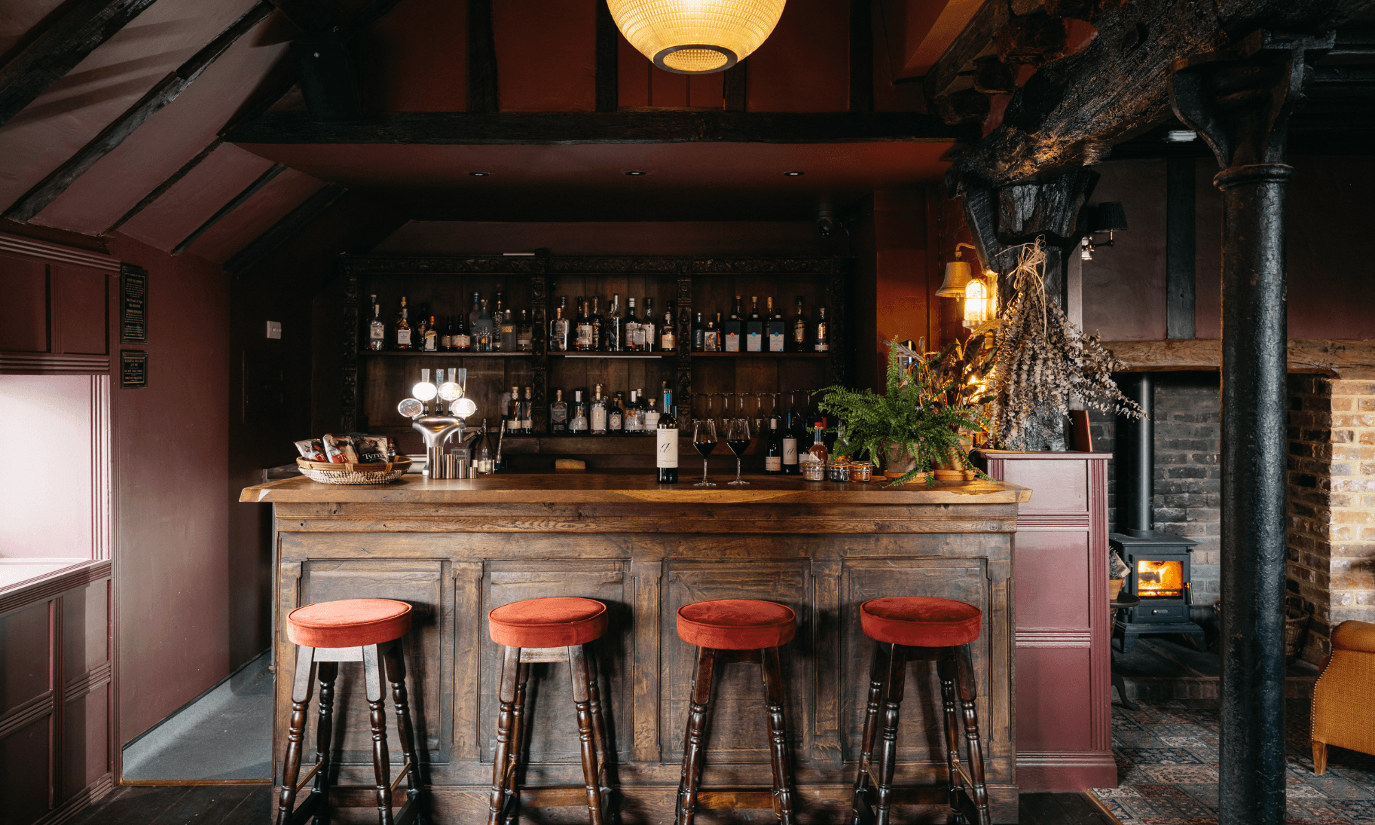 Image may contain: Pub, Alcohol, Bar, Bar Counter, Beverage, Bar Stool, Furniture, and Plant